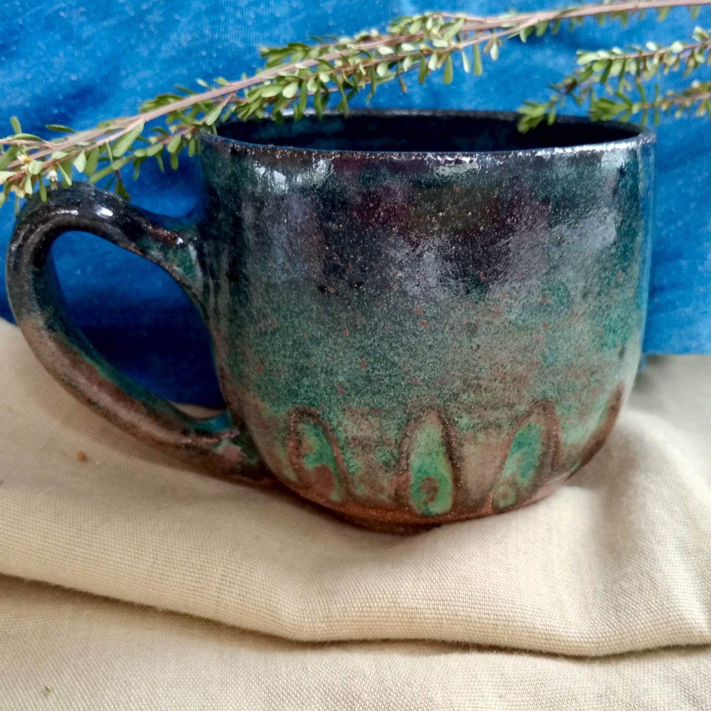 Blue & teal mug on rustic dark clay