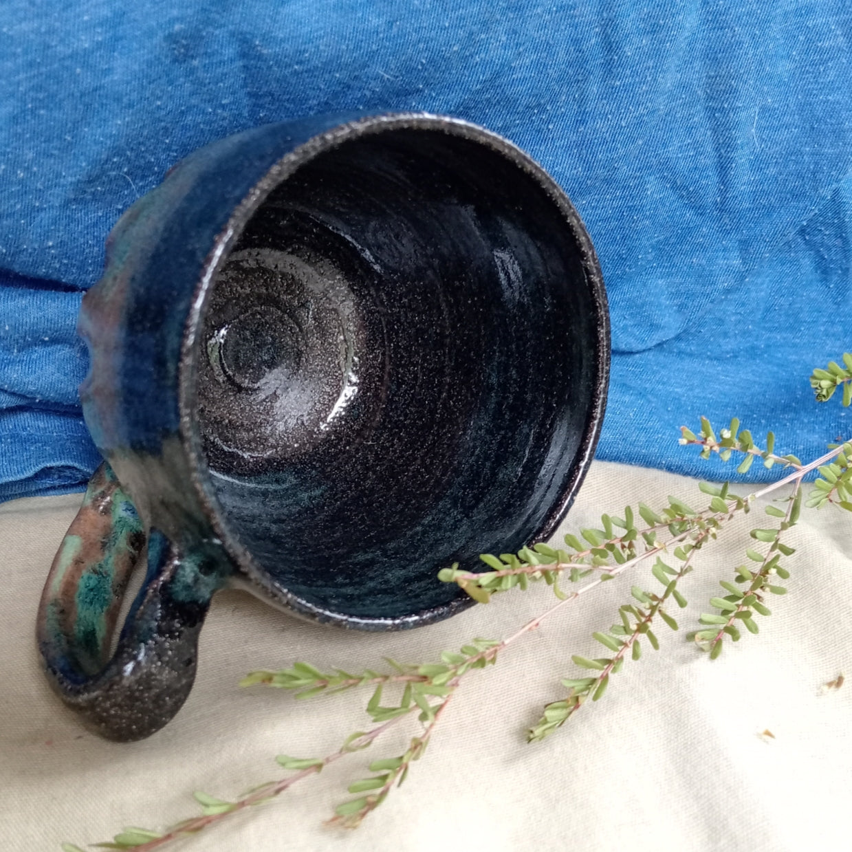 Blue & teal mug on rustic dark clay