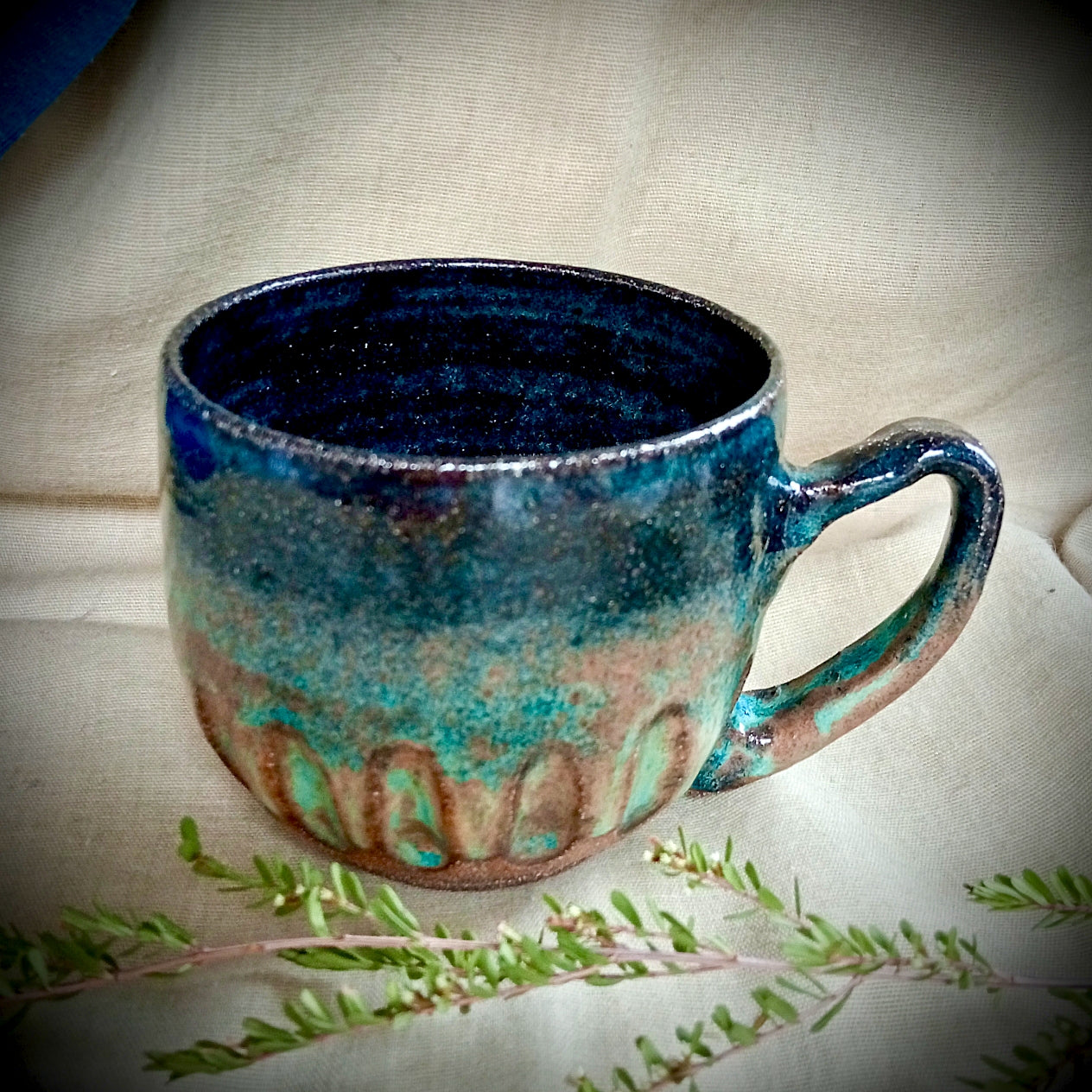 Blue & teal mug on rustic dark clay