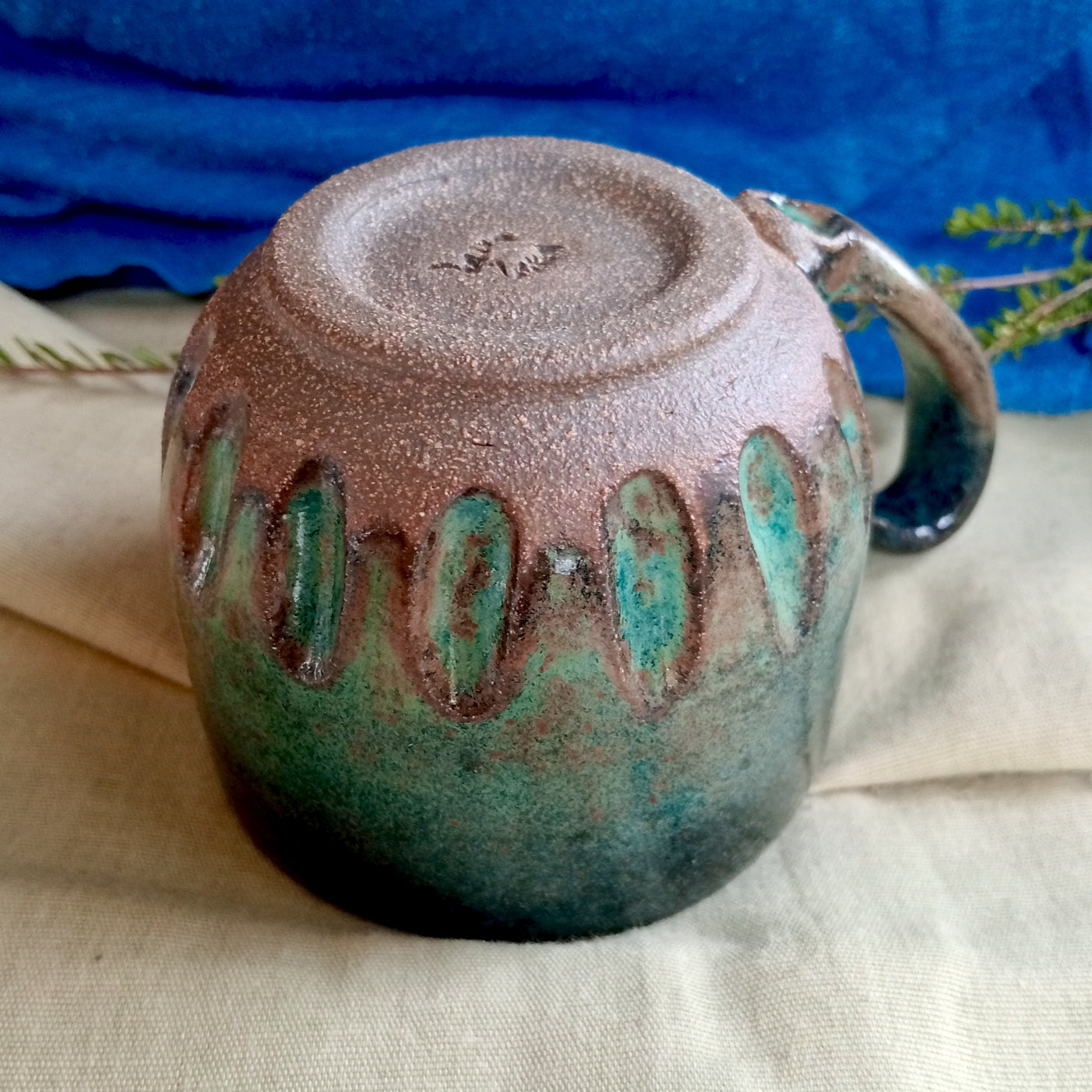 Blue & teal mug on rustic dark clay