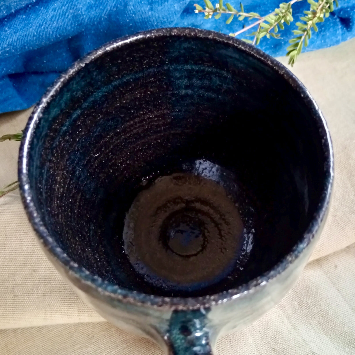 Blue & teal mug on rustic dark clay