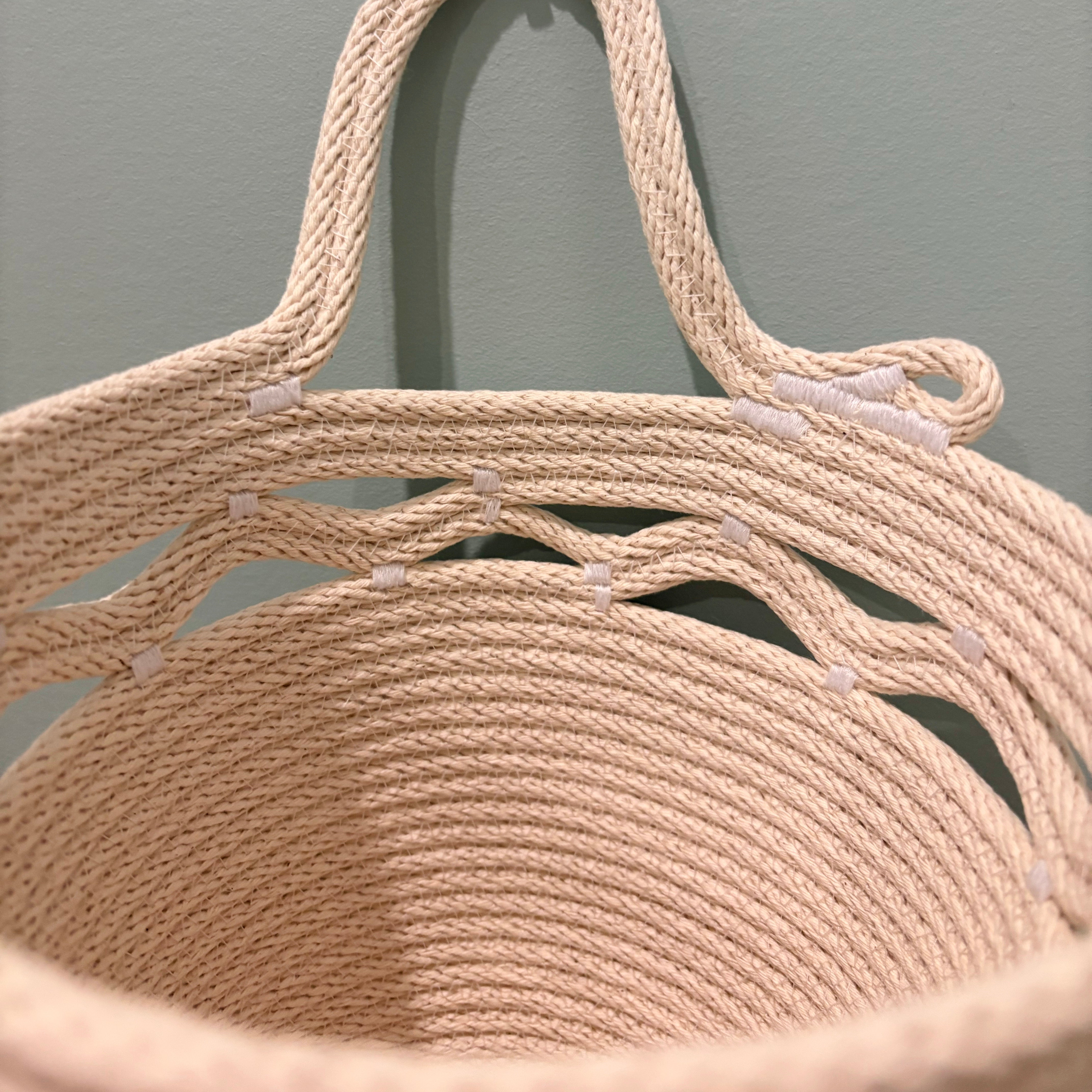 Hanging storage basket with wavy detail