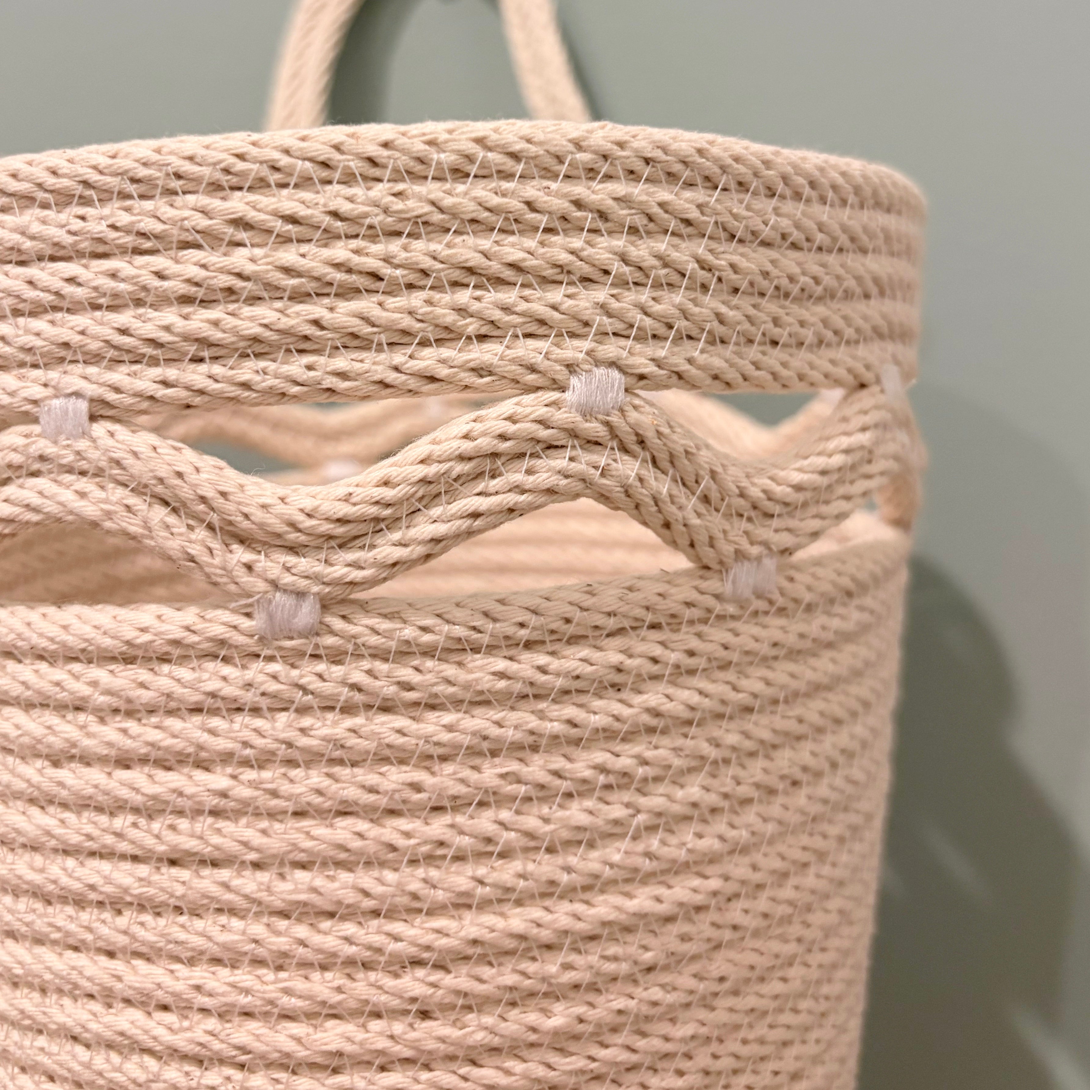 Hanging storage basket with wavy detail