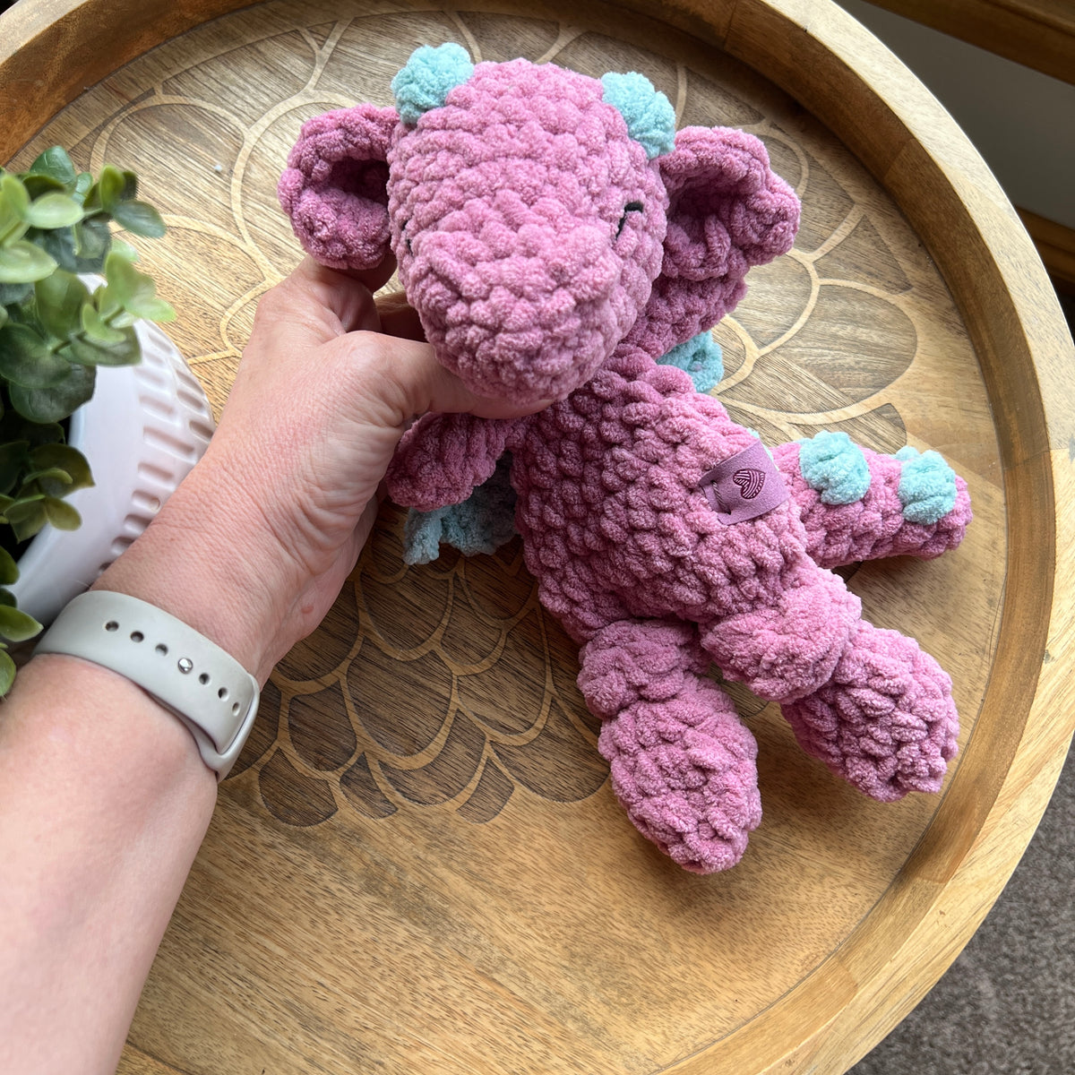 Handmade crochet Mini Dragon modern lovey with knotted legs and rainbow spikes.