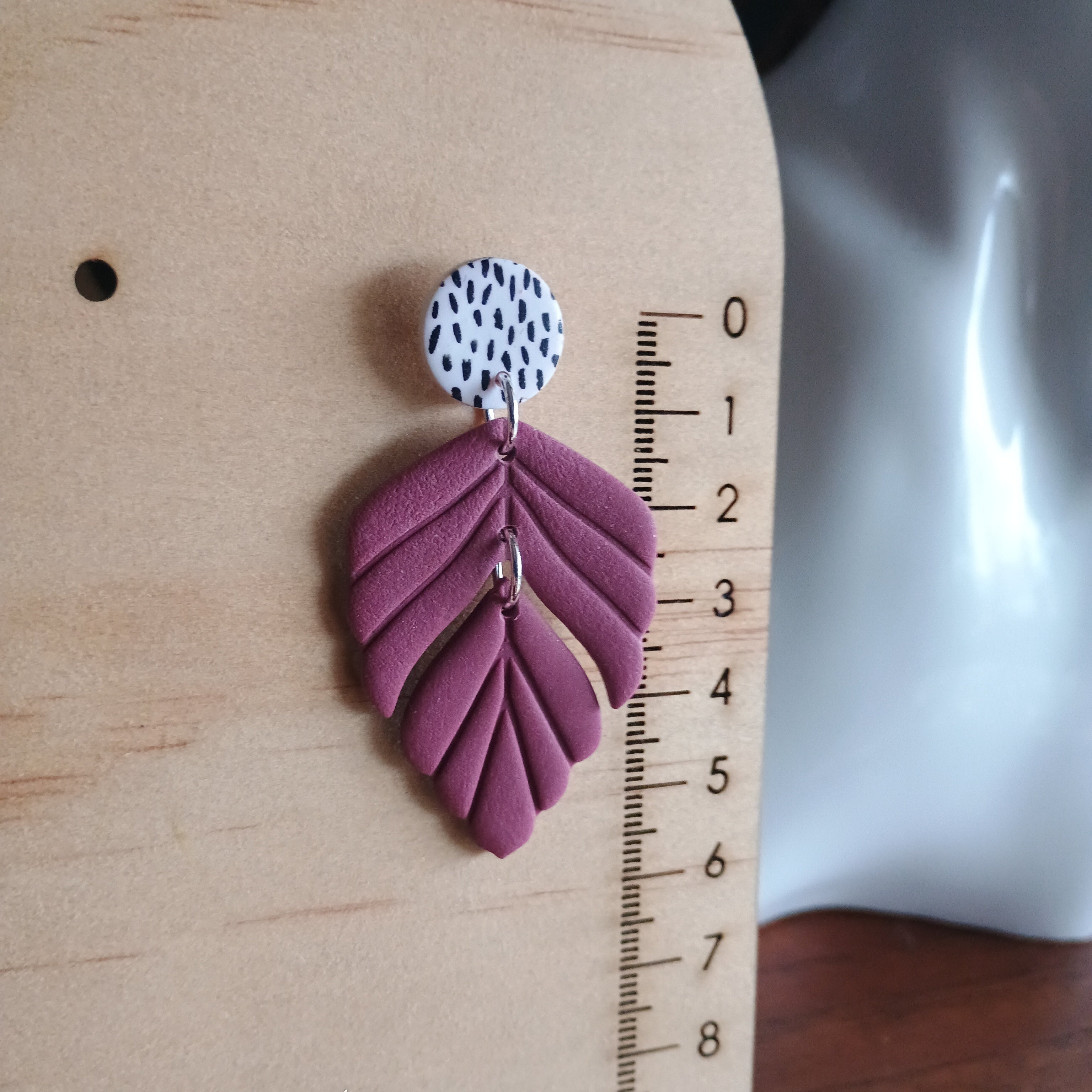 Plum coloured embossed leaf earrings with silkscreen painted stud