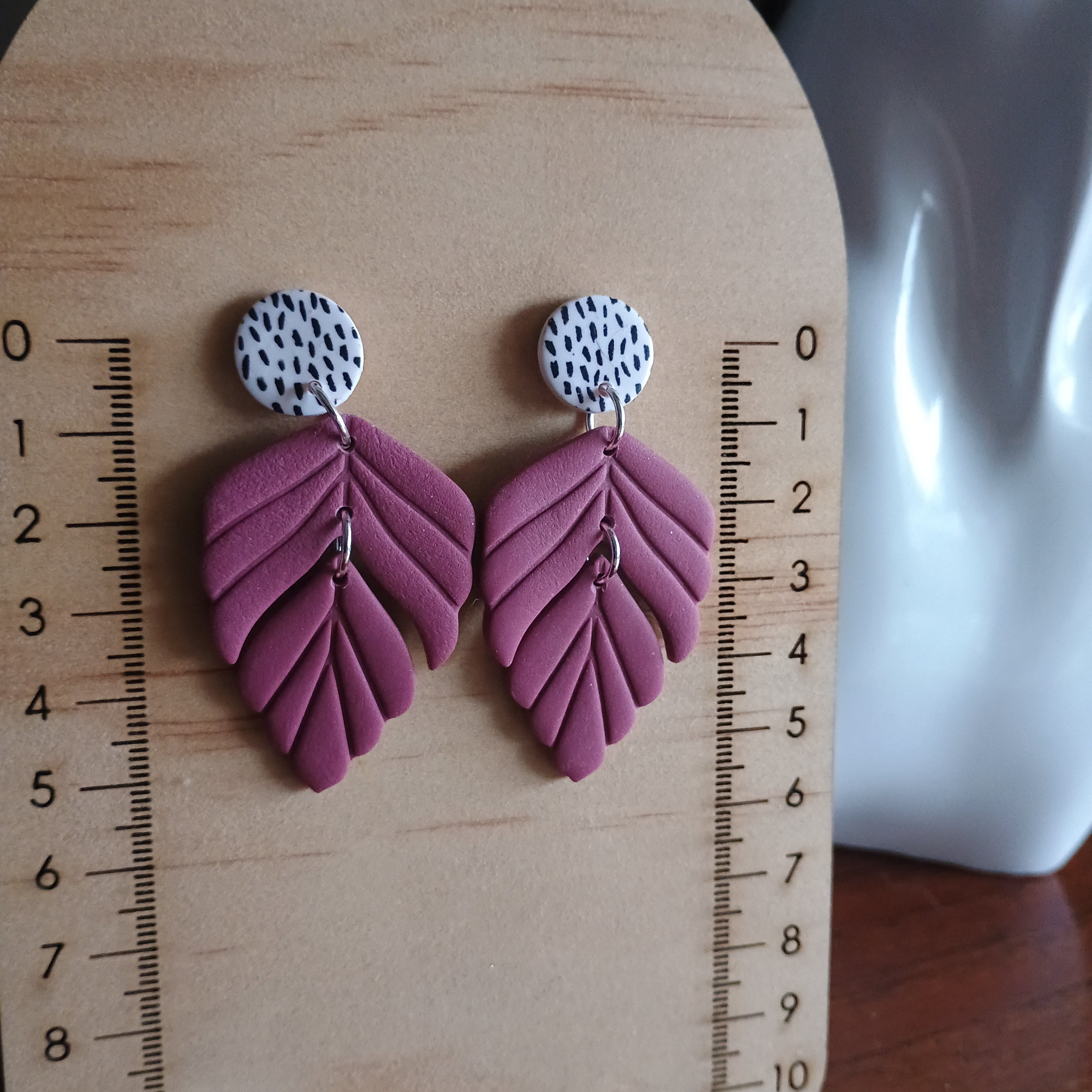 Plum coloured embossed leaf earrings with silkscreen painted stud