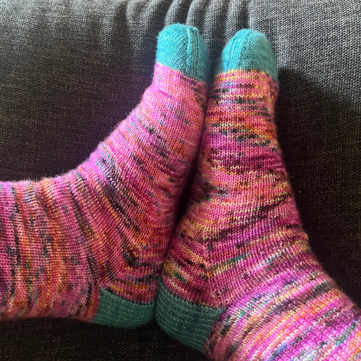 Hand knit socks using Australian hand dyed yarn - pink with teal highlights