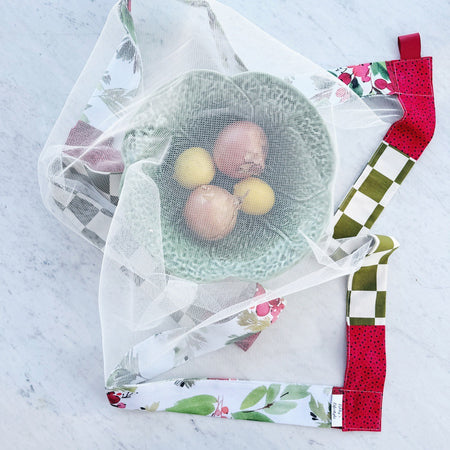 Red and green weighted mesh food cover.