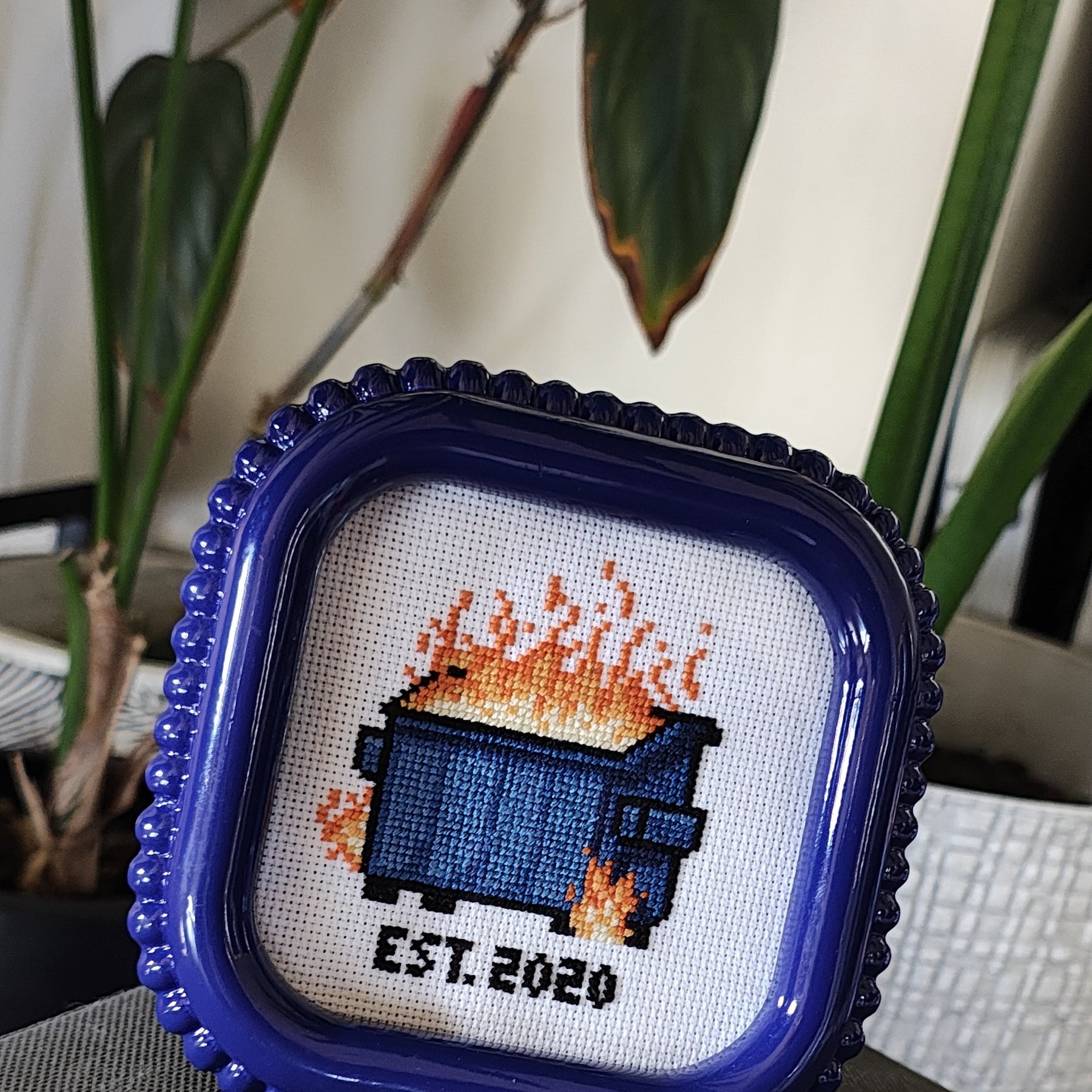 "Dumpster fire" framed cross stitch