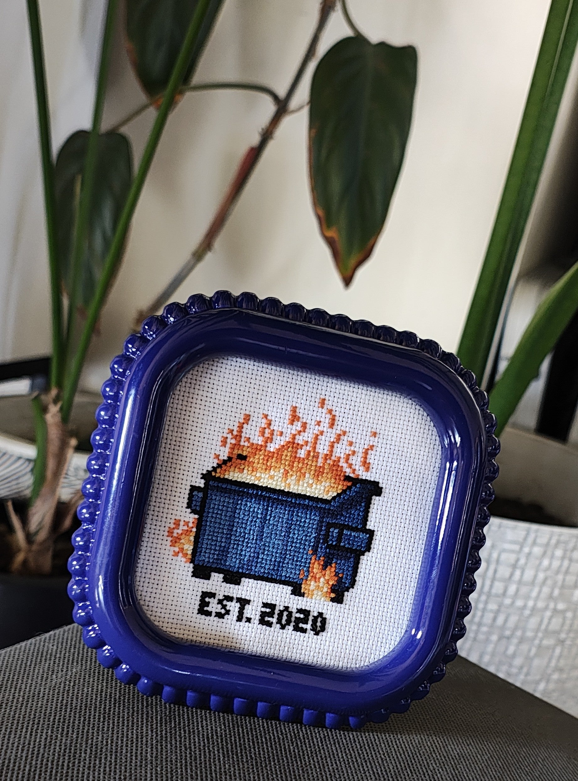 "Dumpster fire" framed cross stitch