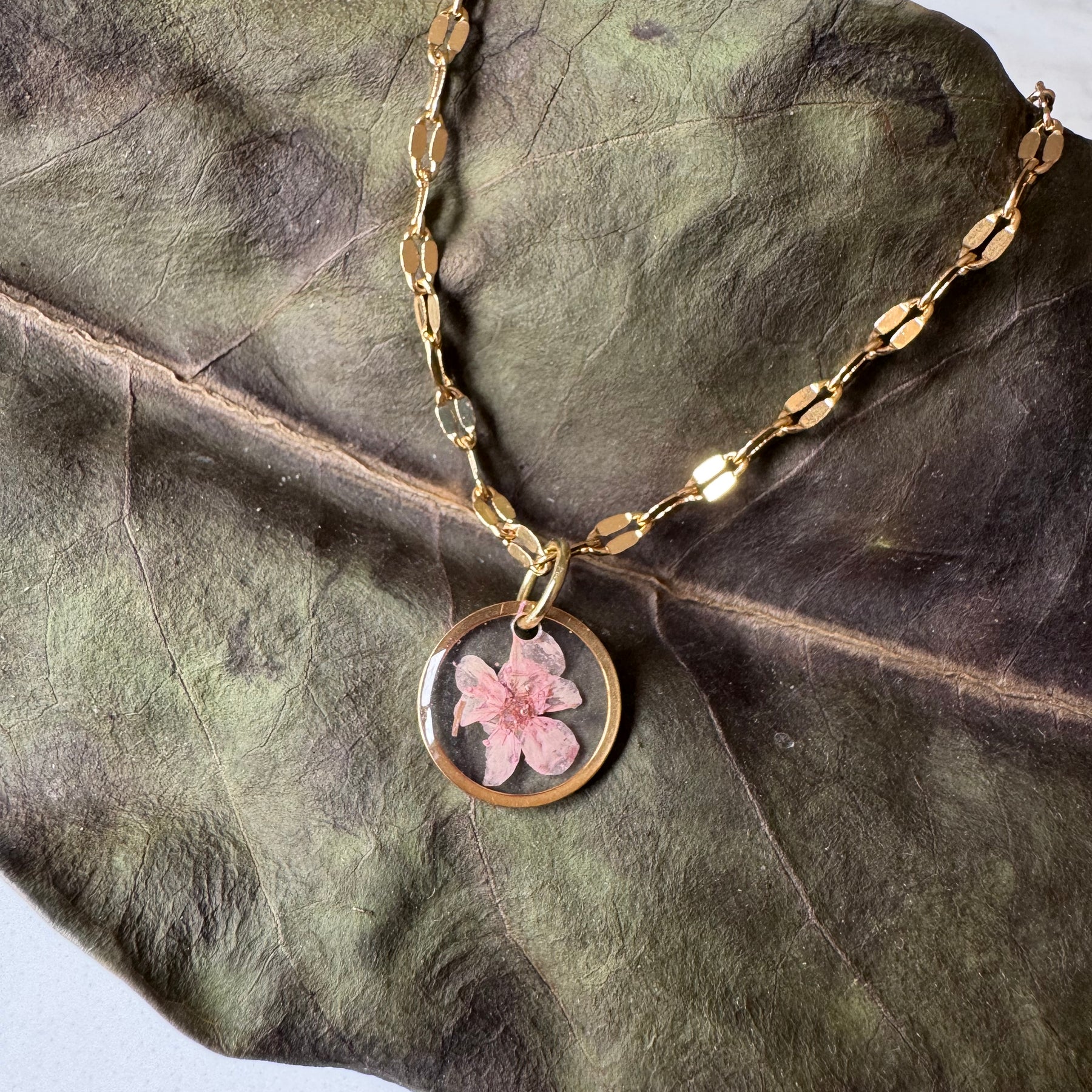 Gold plated resin necklace with pink wildflower
