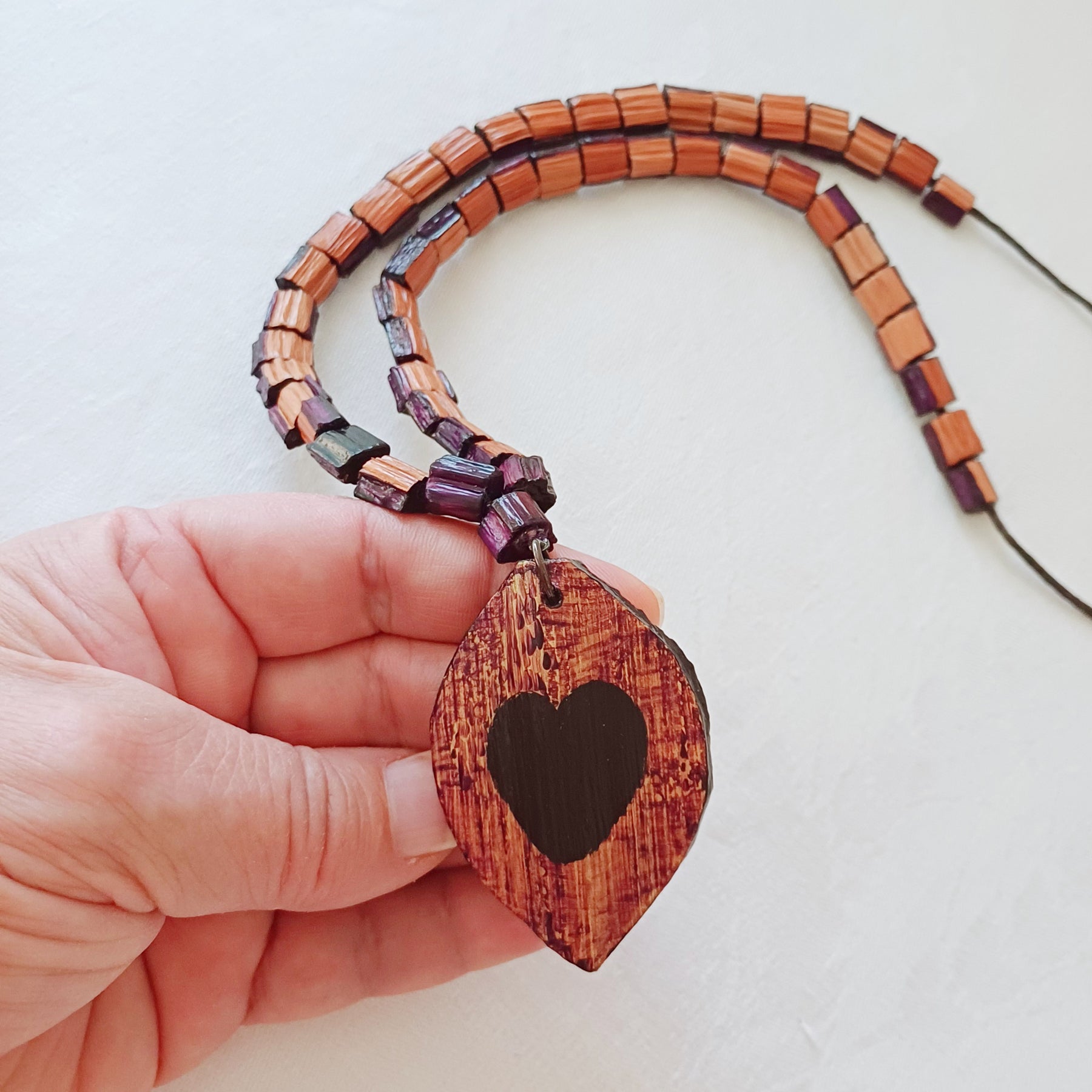 Hand painted Heart pendant on palm leaf bead necklace