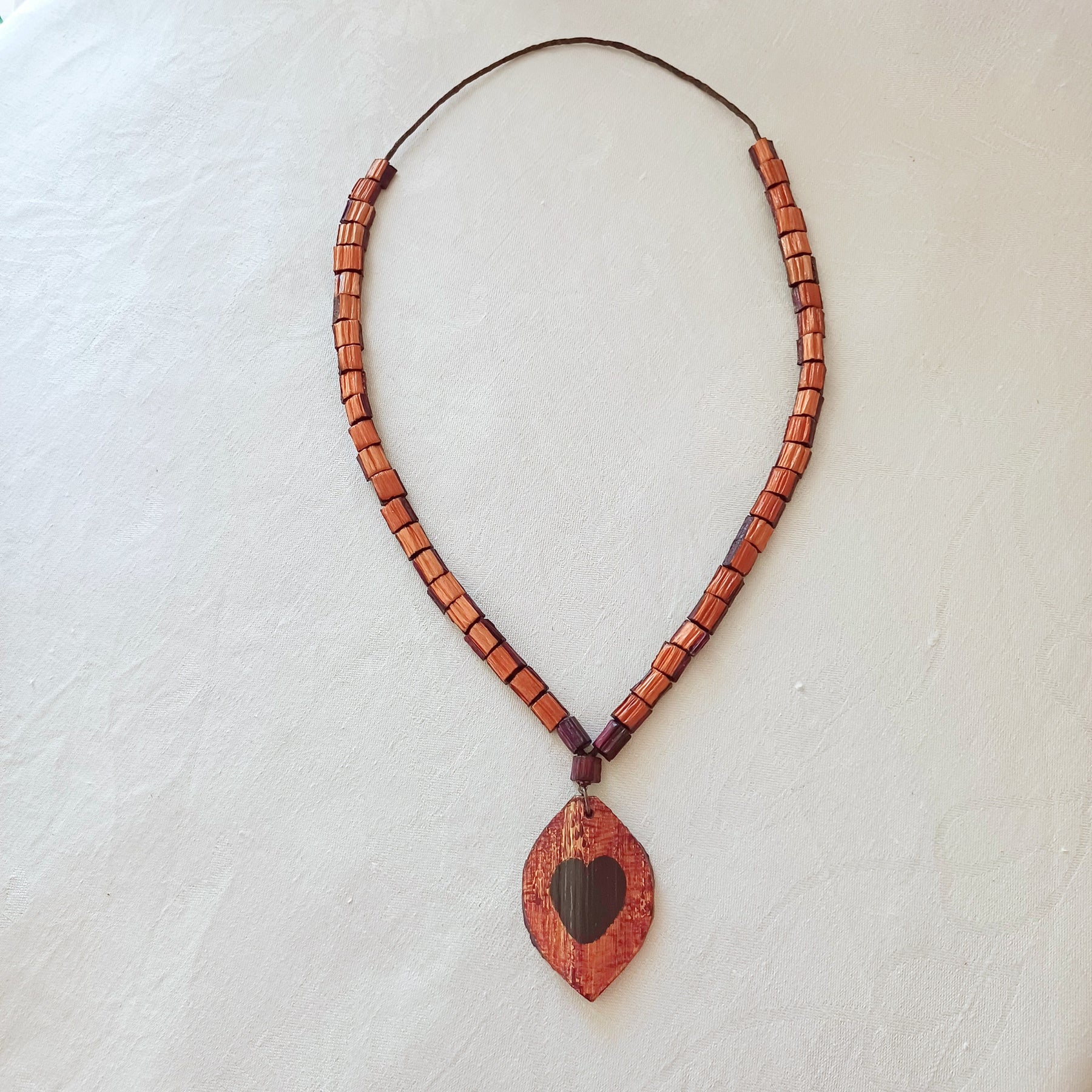 Hand painted Heart pendant on palm leaf bead necklace