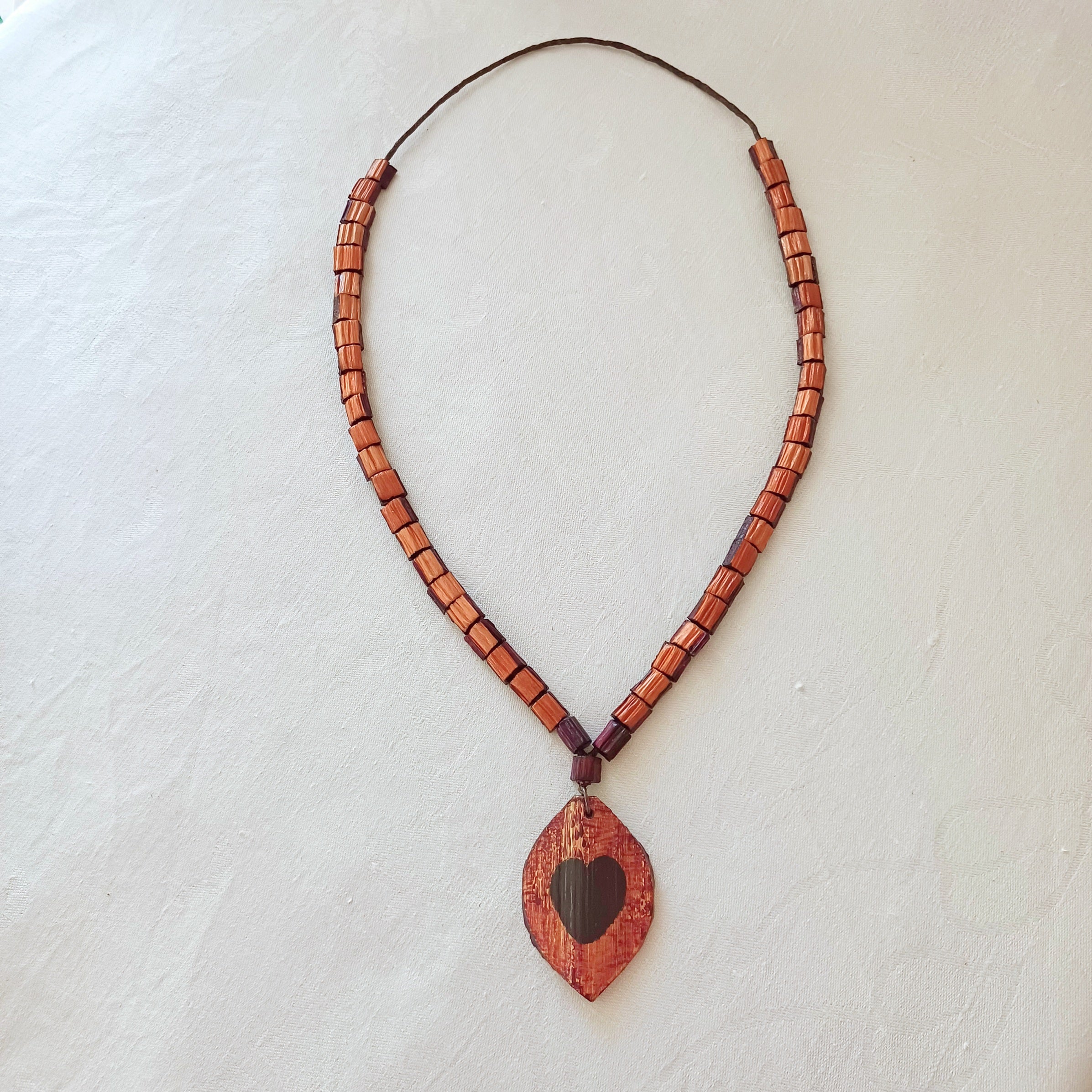 Hand painted Heart pendant on palm leaf bead necklace