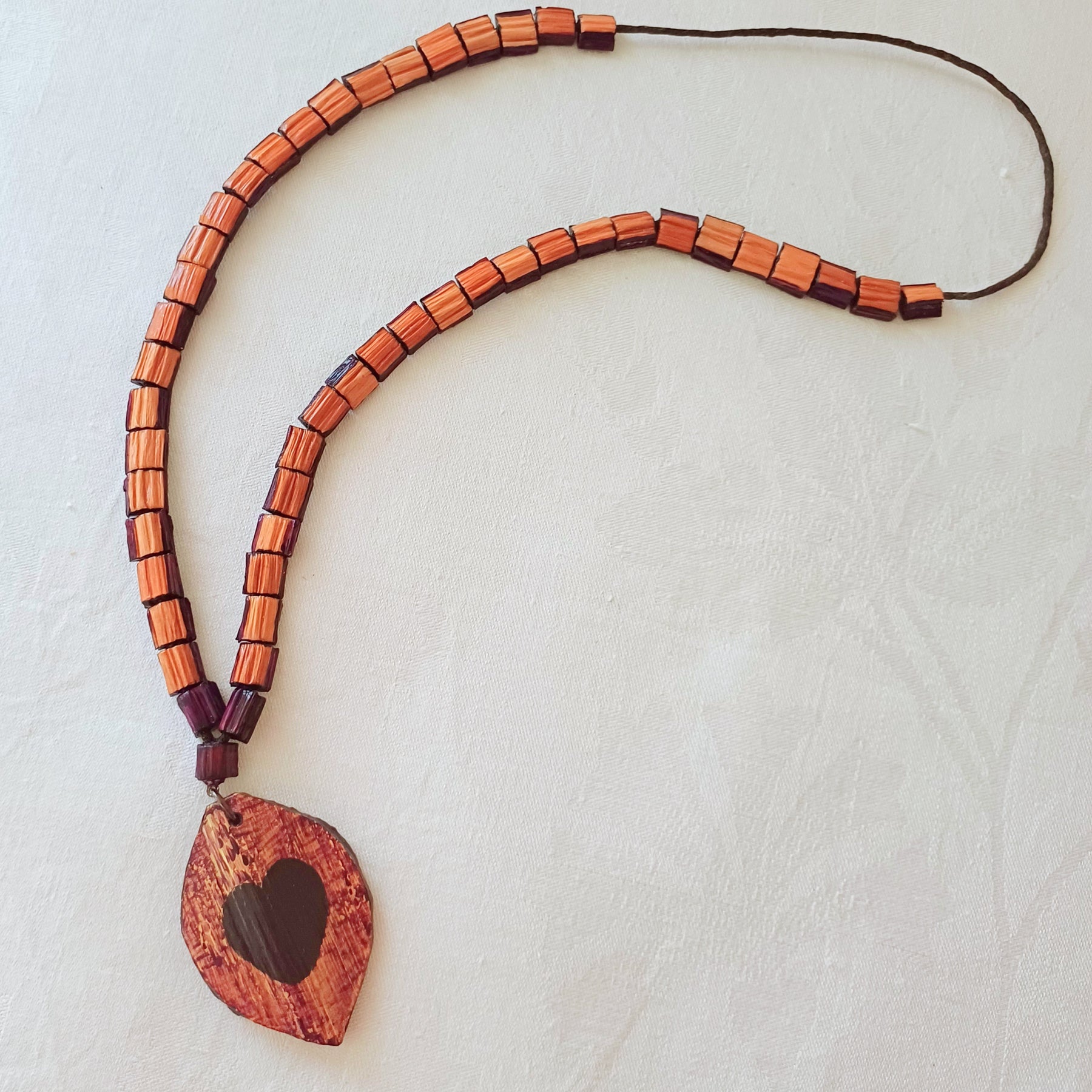 Hand painted Heart pendant on palm leaf bead necklace