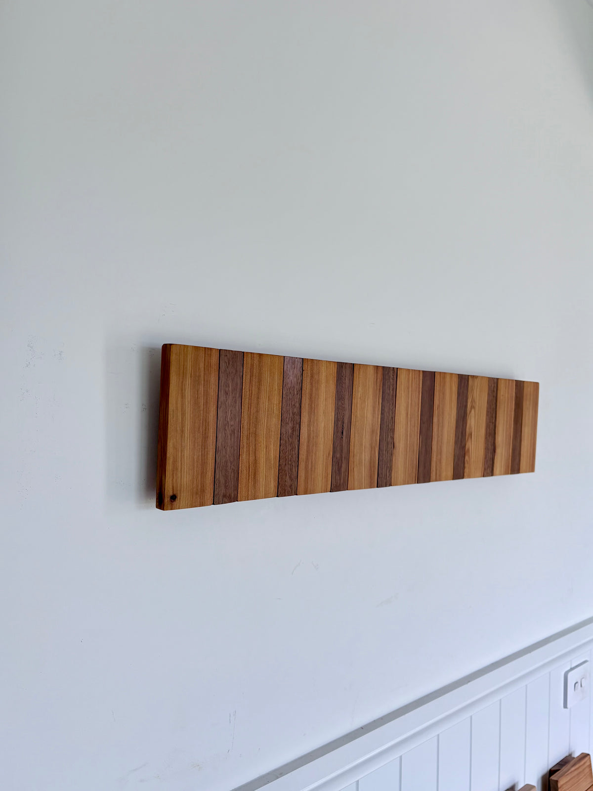Two tone spotted gum and cypress horizon line piano style coatrack