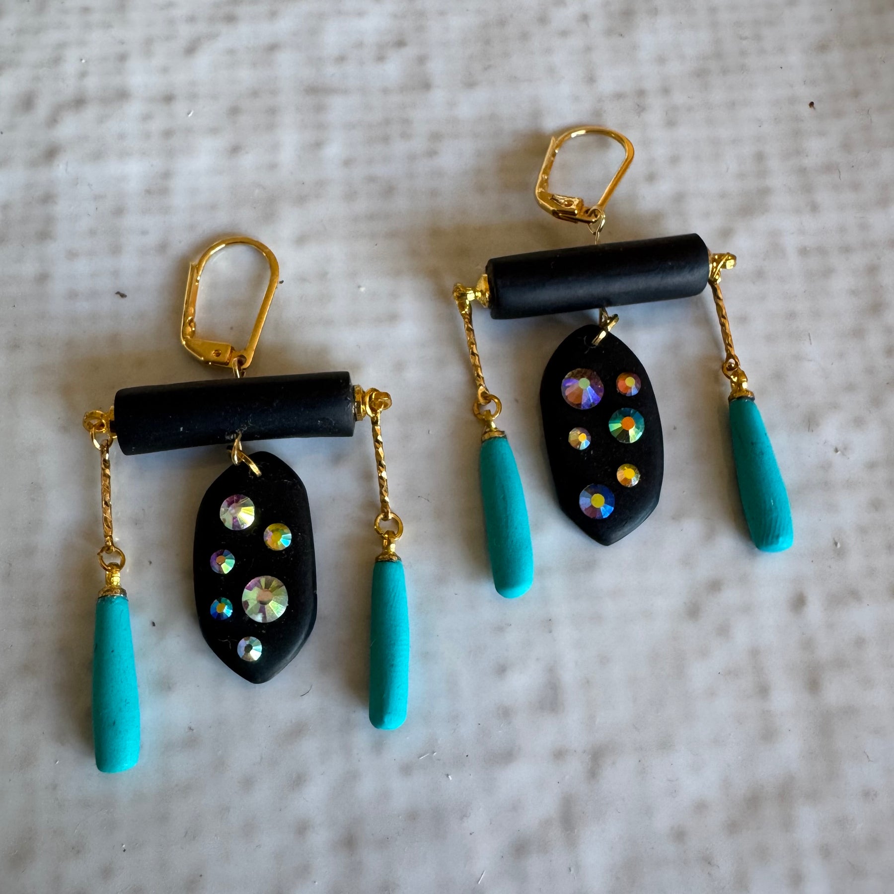Black rod earrings with holographic gems