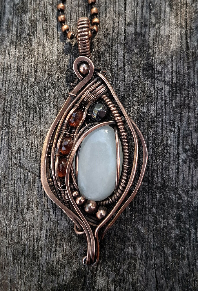 white moonstone garnets and Hematite wirewrap