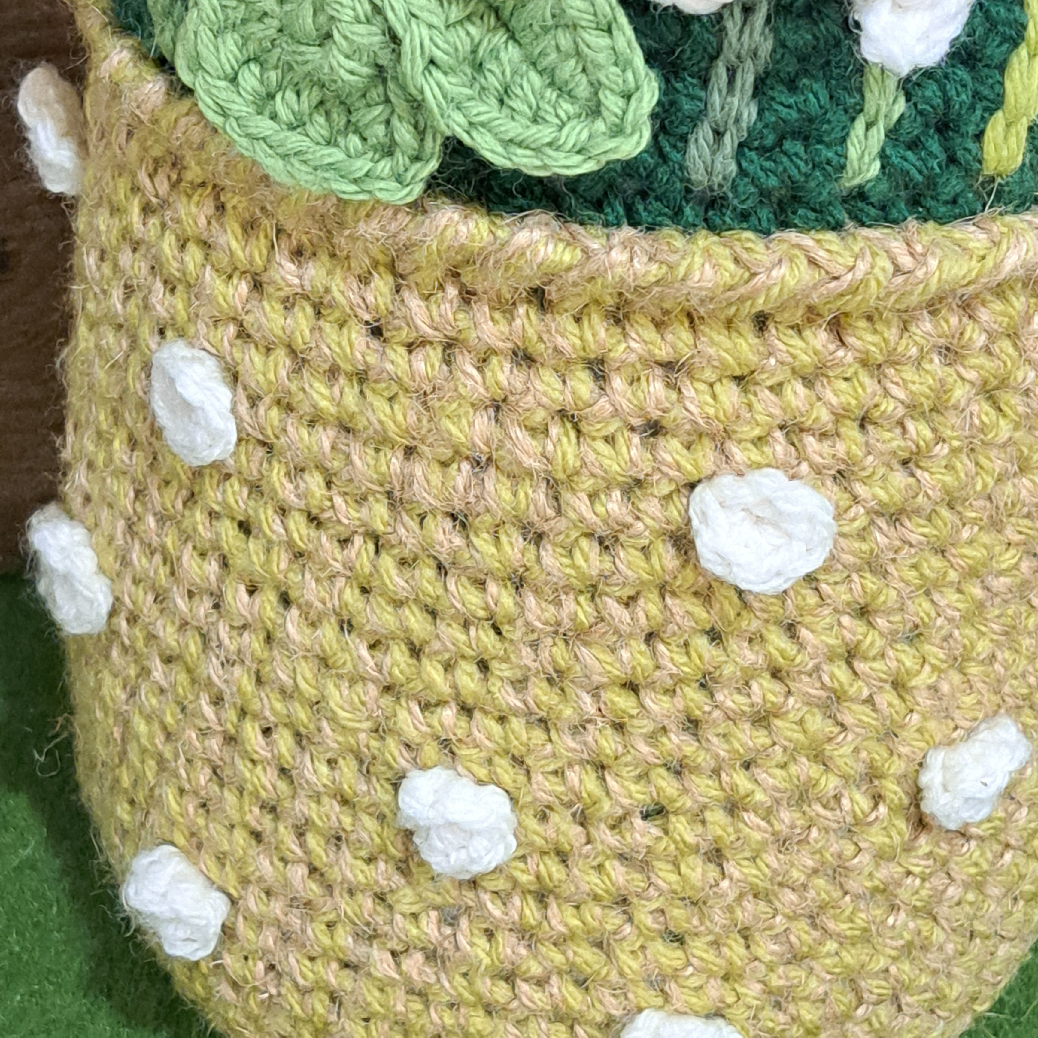 Crochet doorstop/ spring flowers in a yellow vase.