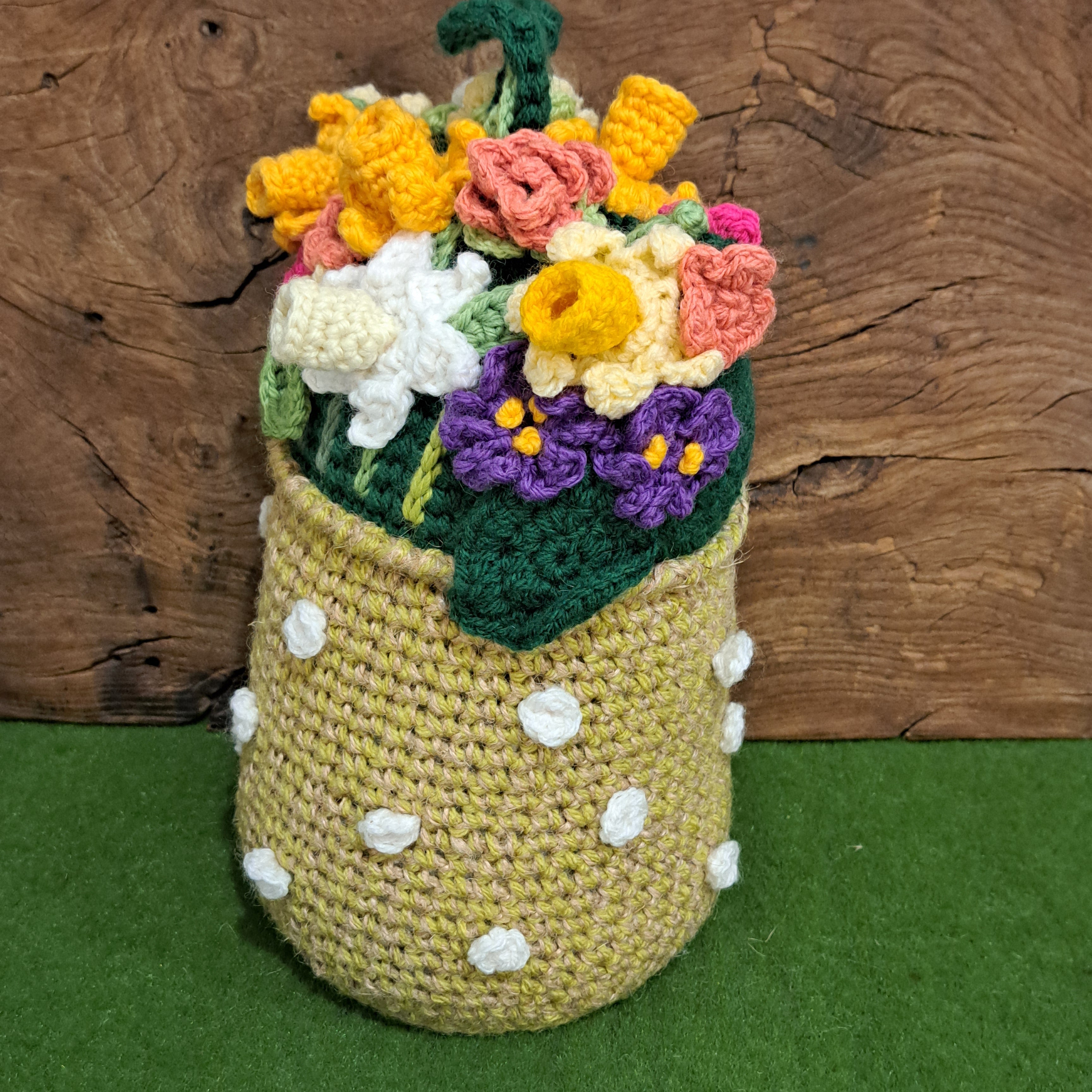 Crochet doorstop/ spring flowers in a yellow vase.