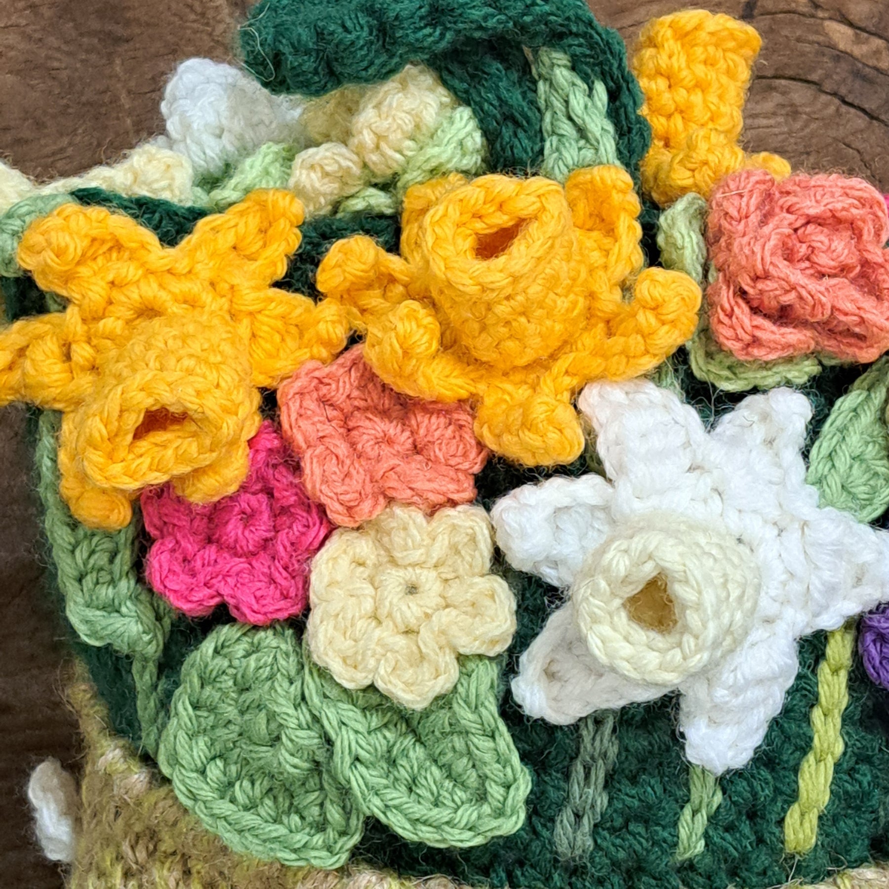 Crochet doorstop/ spring flowers in a yellow vase.