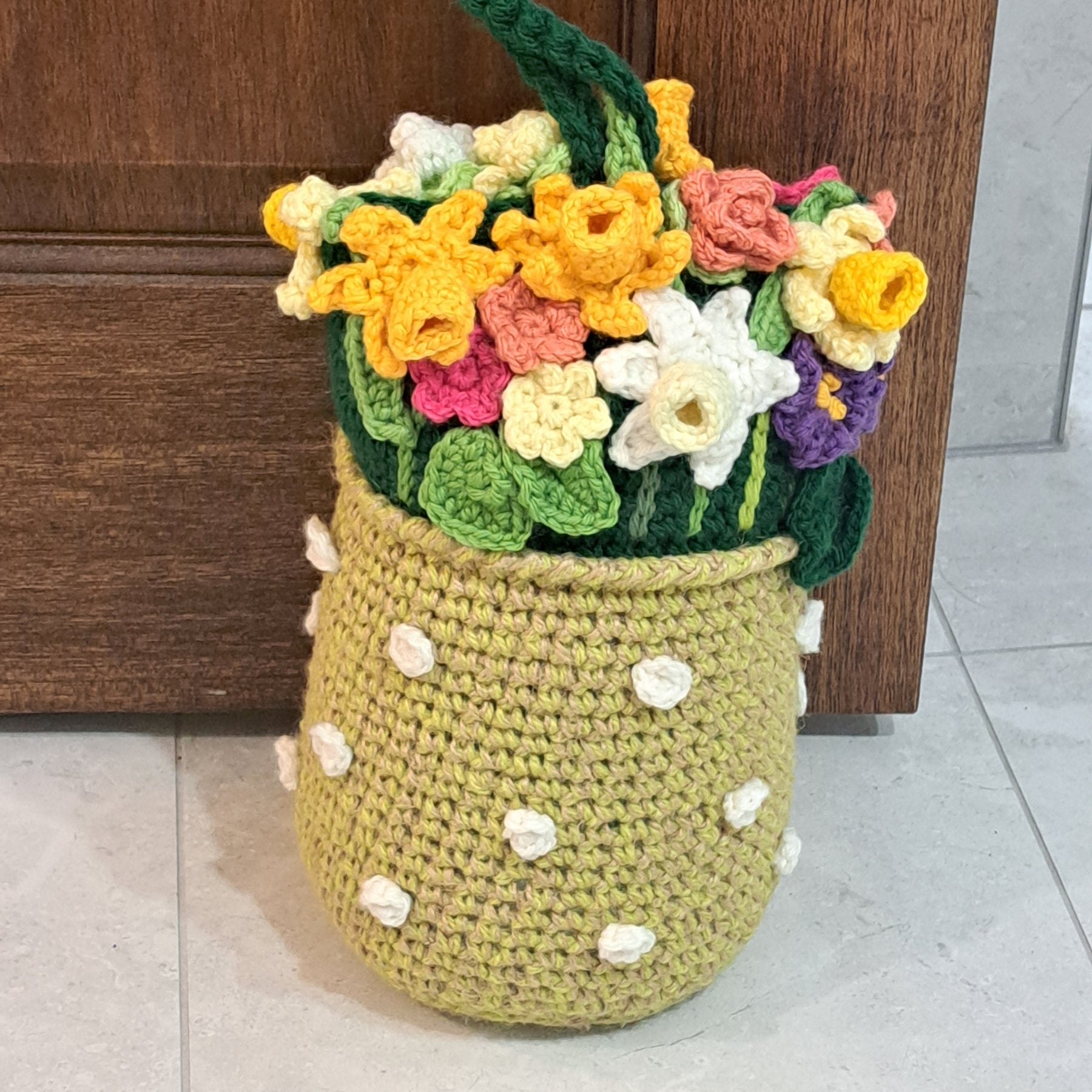 Crochet doorstop/ spring flowers in a yellow vase.