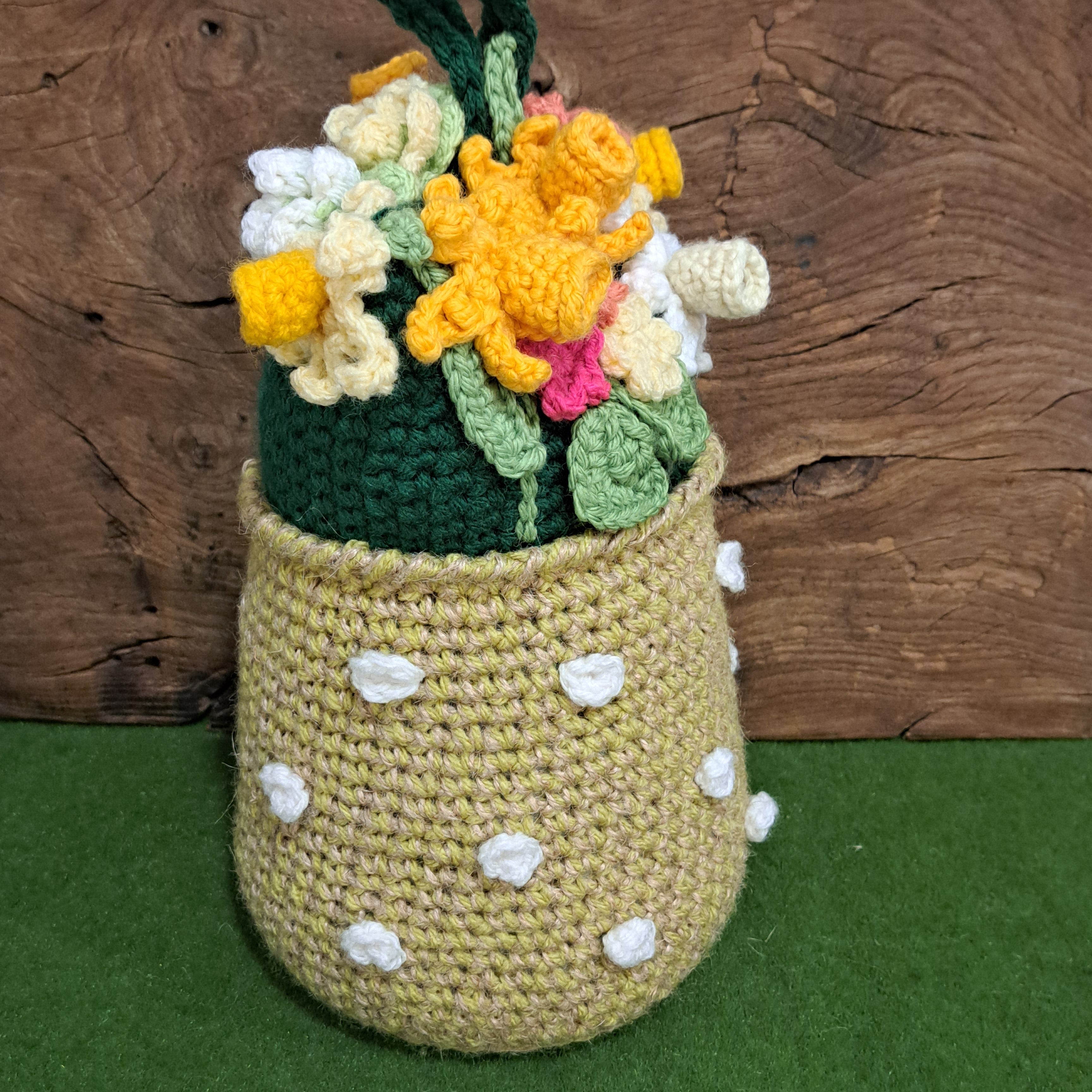 Crochet doorstop/ spring flowers in a yellow vase.