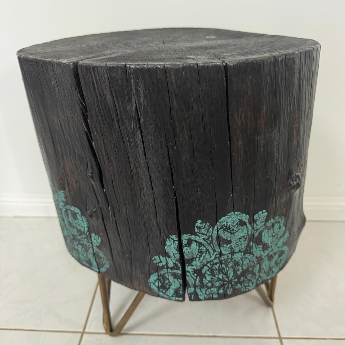 Timber stump table featuring teal mandala hand-painted artwork