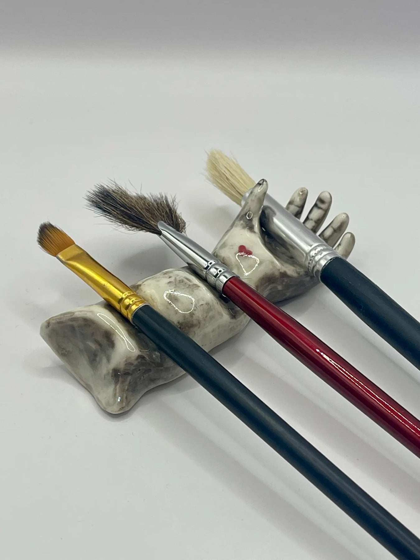 Handmade porcelain ‘helping hand’ brush rest