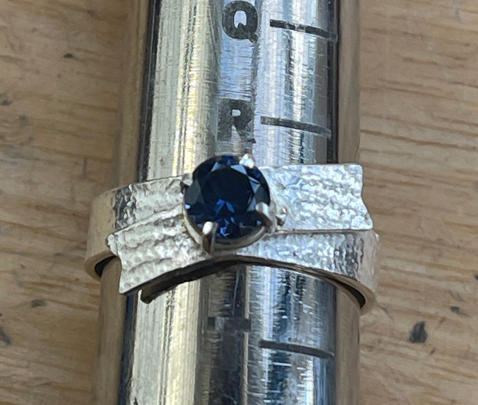 Sterling silver textured ring, bow with blue sapphire