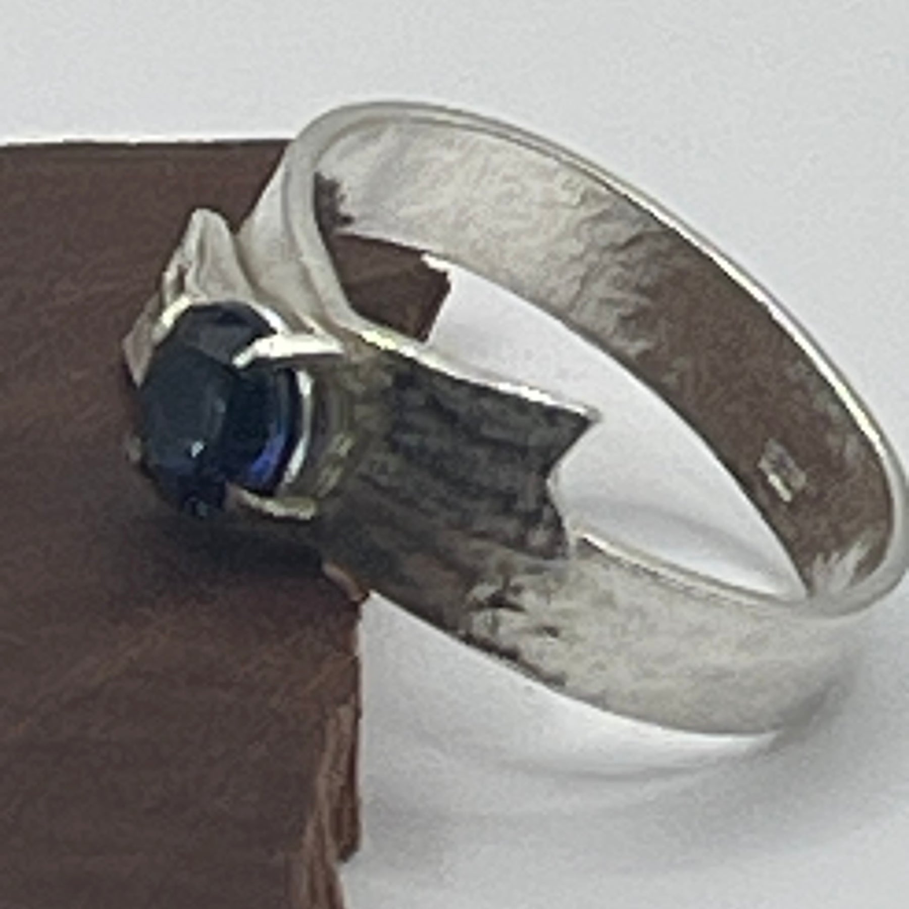 Sterling silver textured ring, bow with blue sapphire