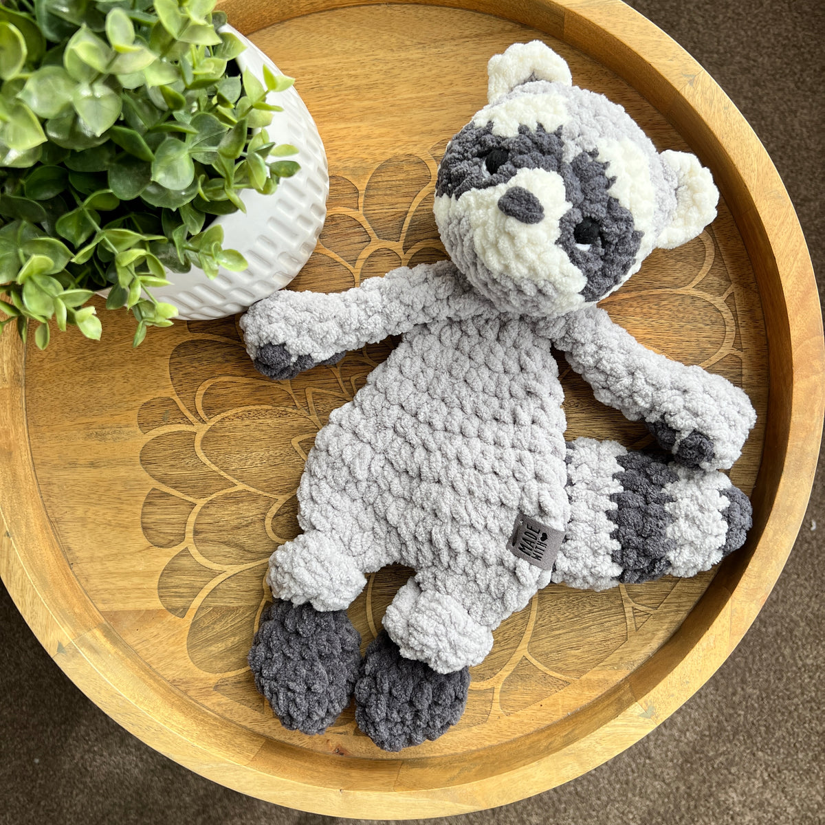 Handmade crochet modern Raccoon lovey snuggler with knotted legs.