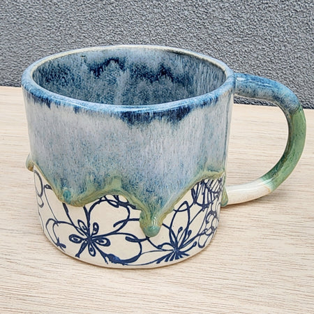 Ceramic floral mug with drippy glaze