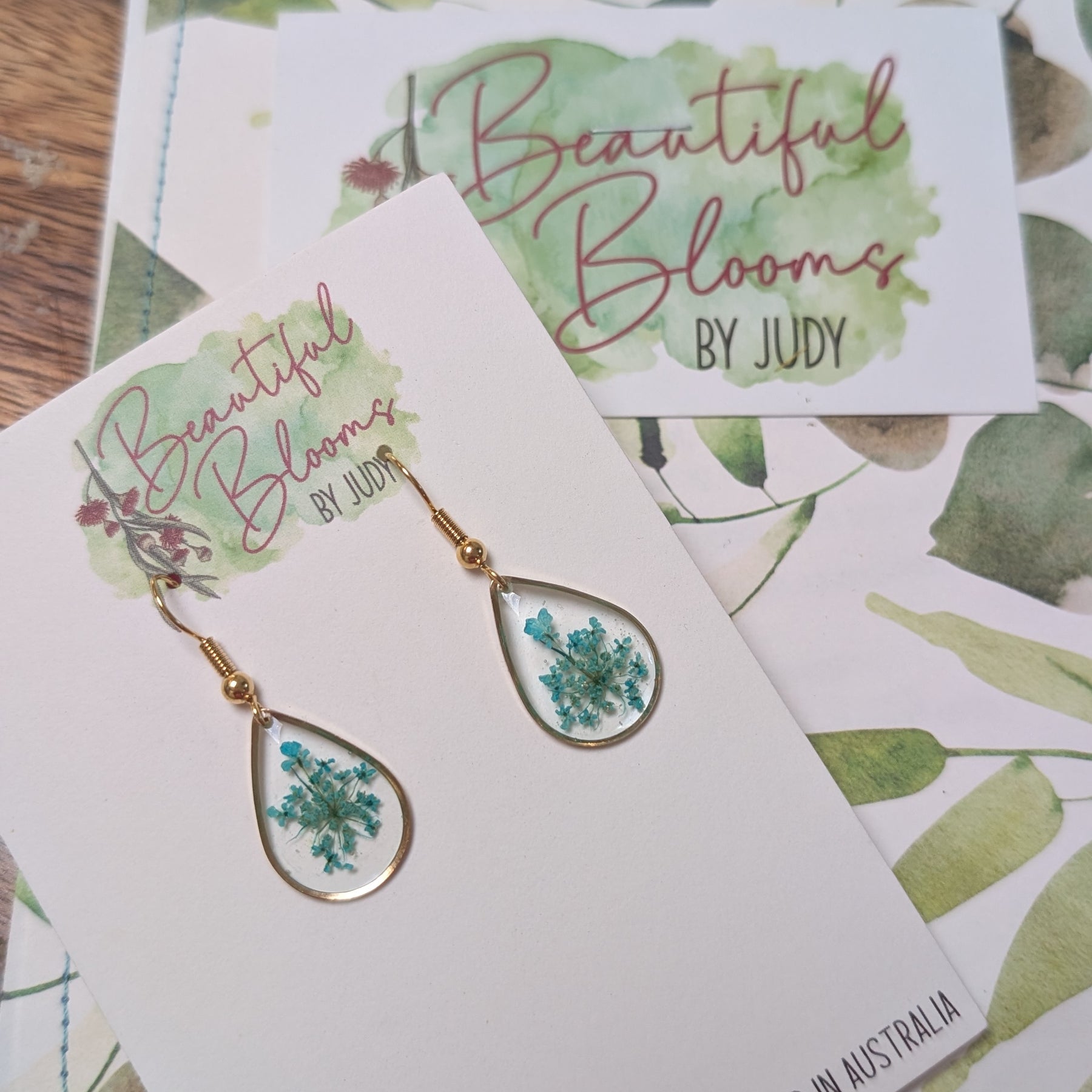 Gold teardrop earrings with teal Queen Anne's Lace