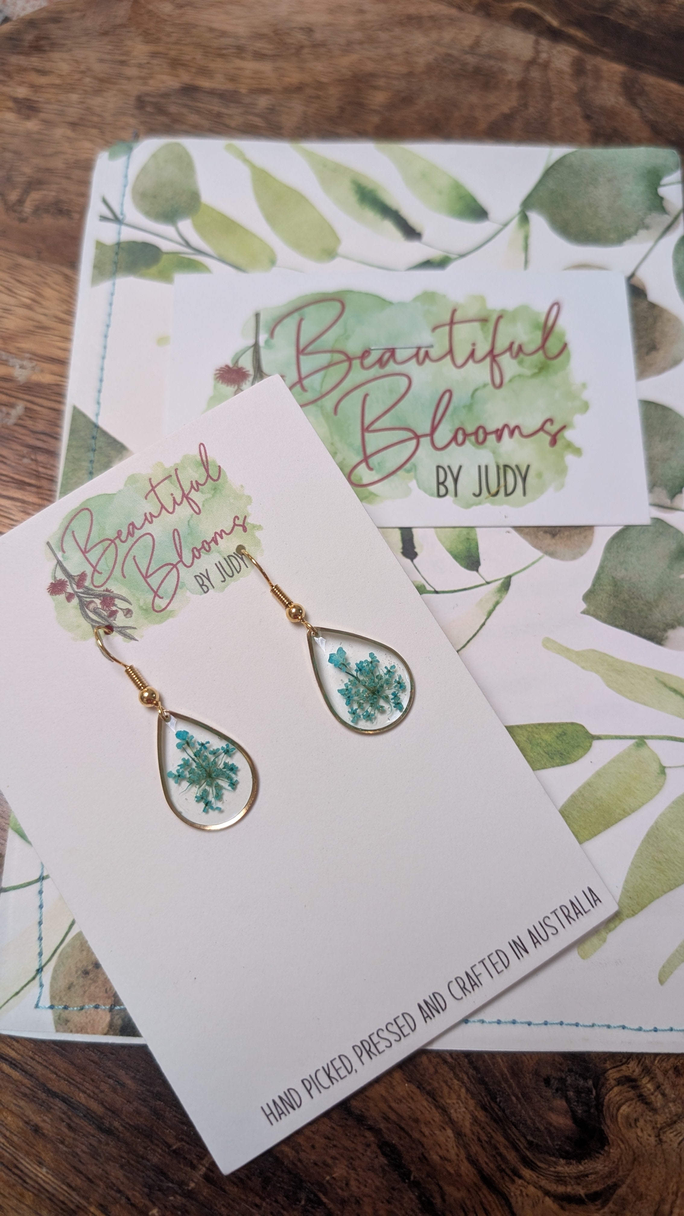 Gold teardrop earrings with teal Queen Anne's Lace