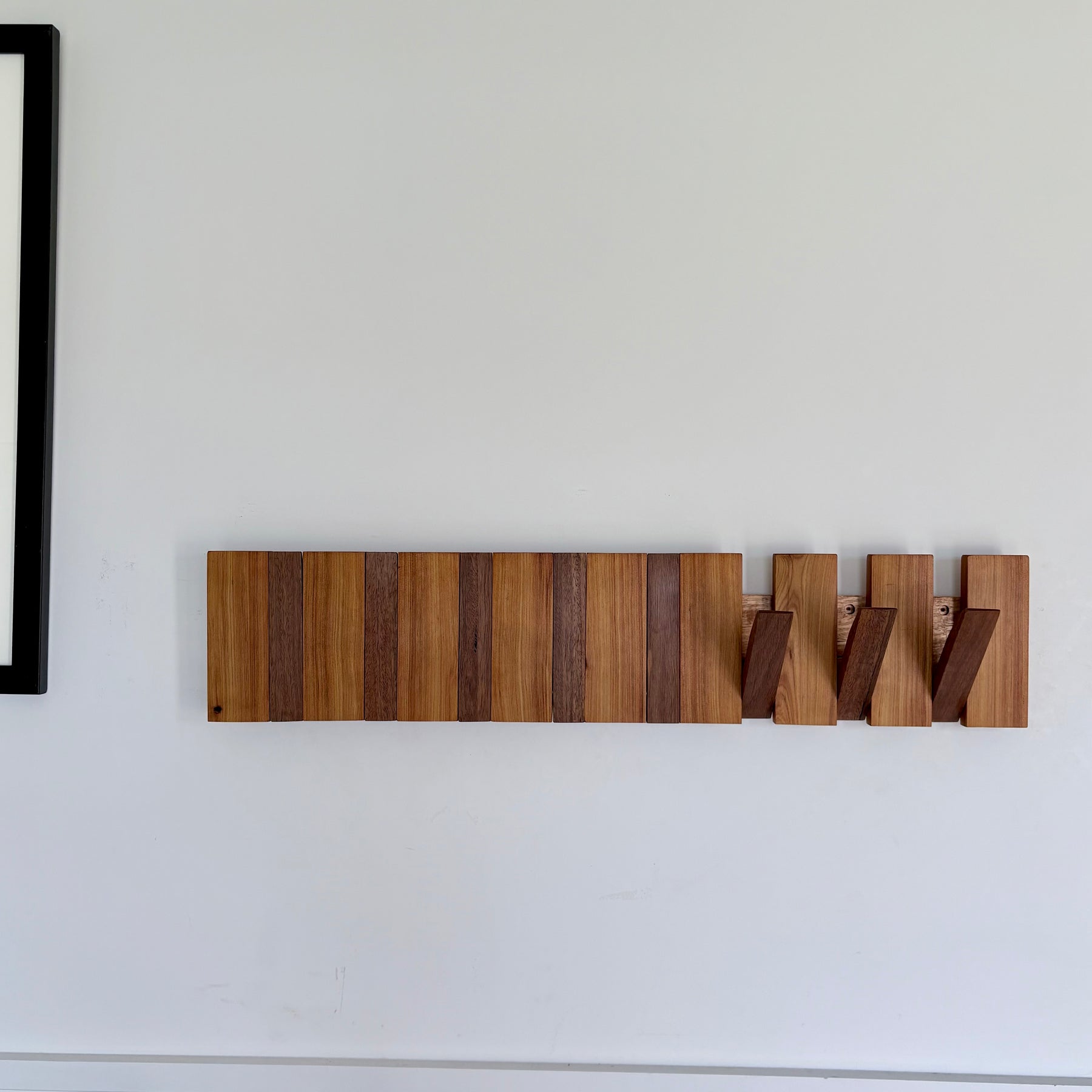 Two tone spotted gum and cypress horizon line piano style coatrack