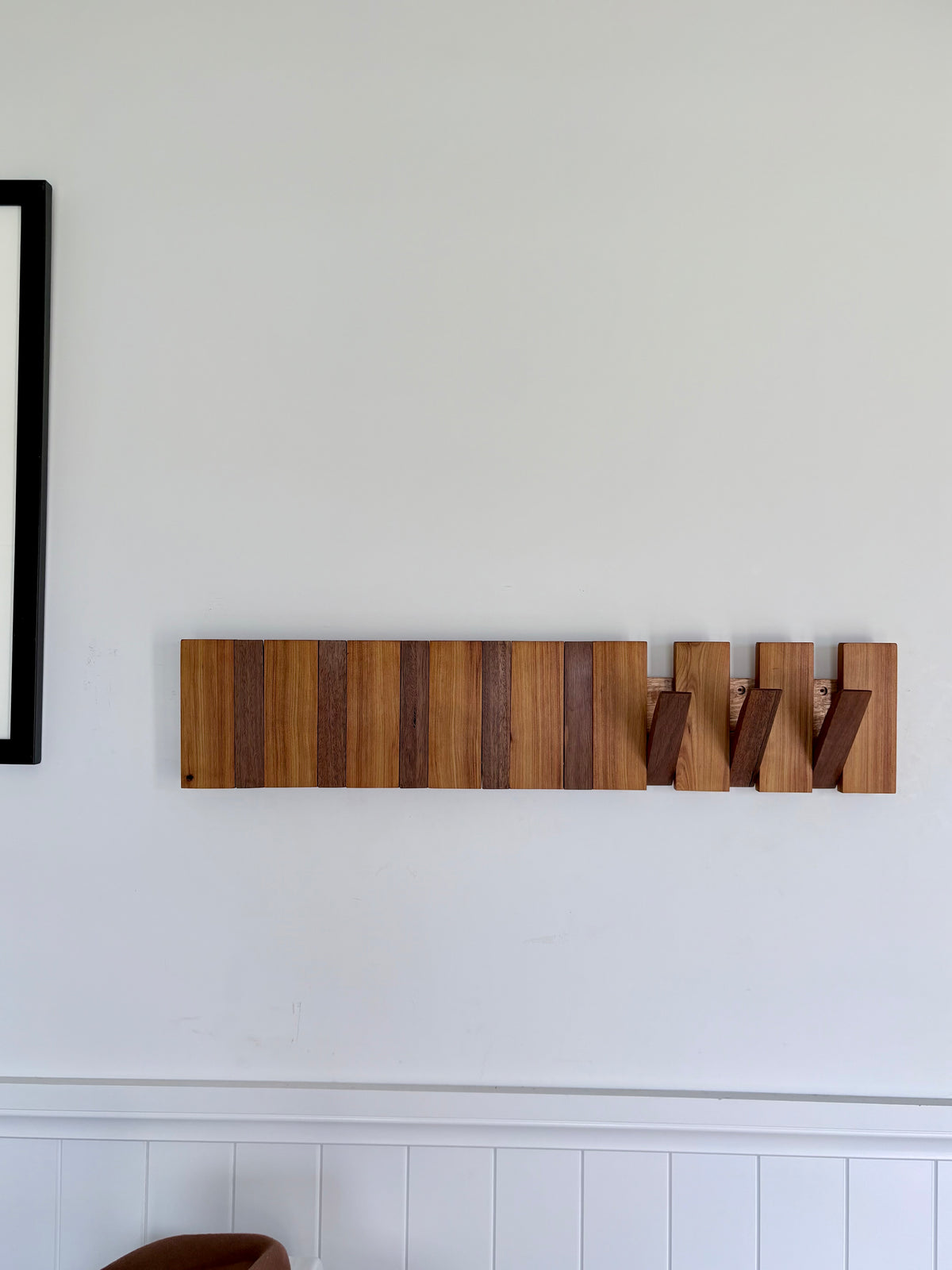 Two tone spotted gum and cypress horizon line piano style coatrack