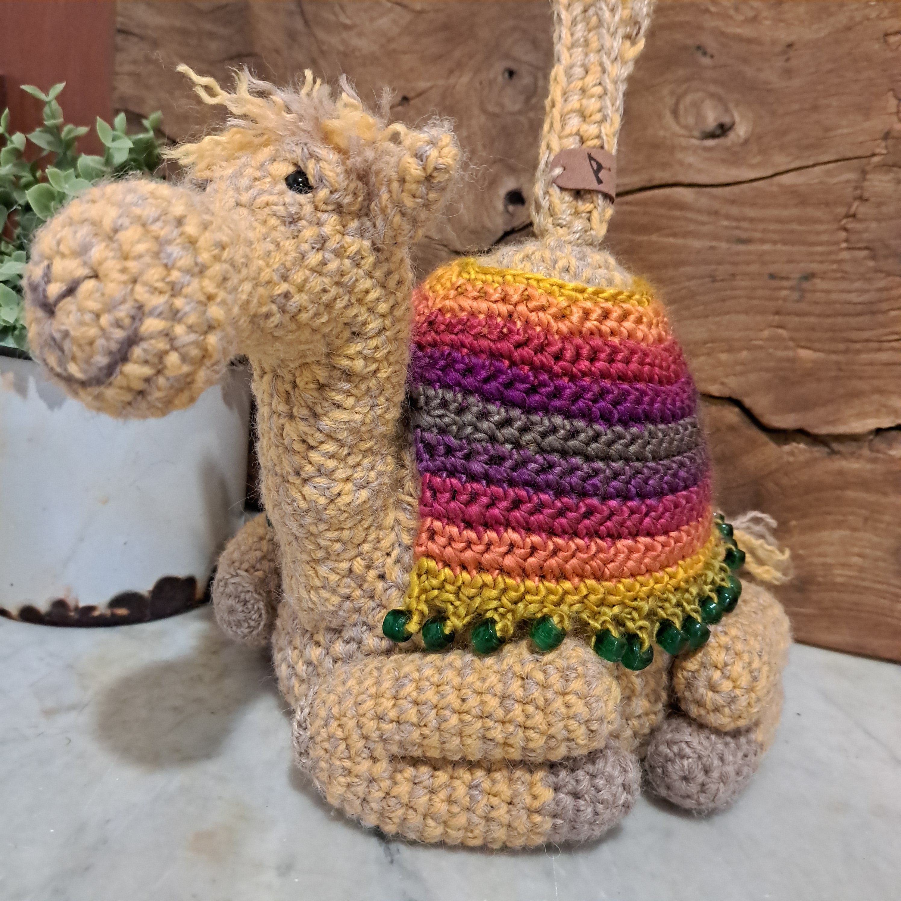 Handmade crochet camel doorstop colourful coat mustard coloured base