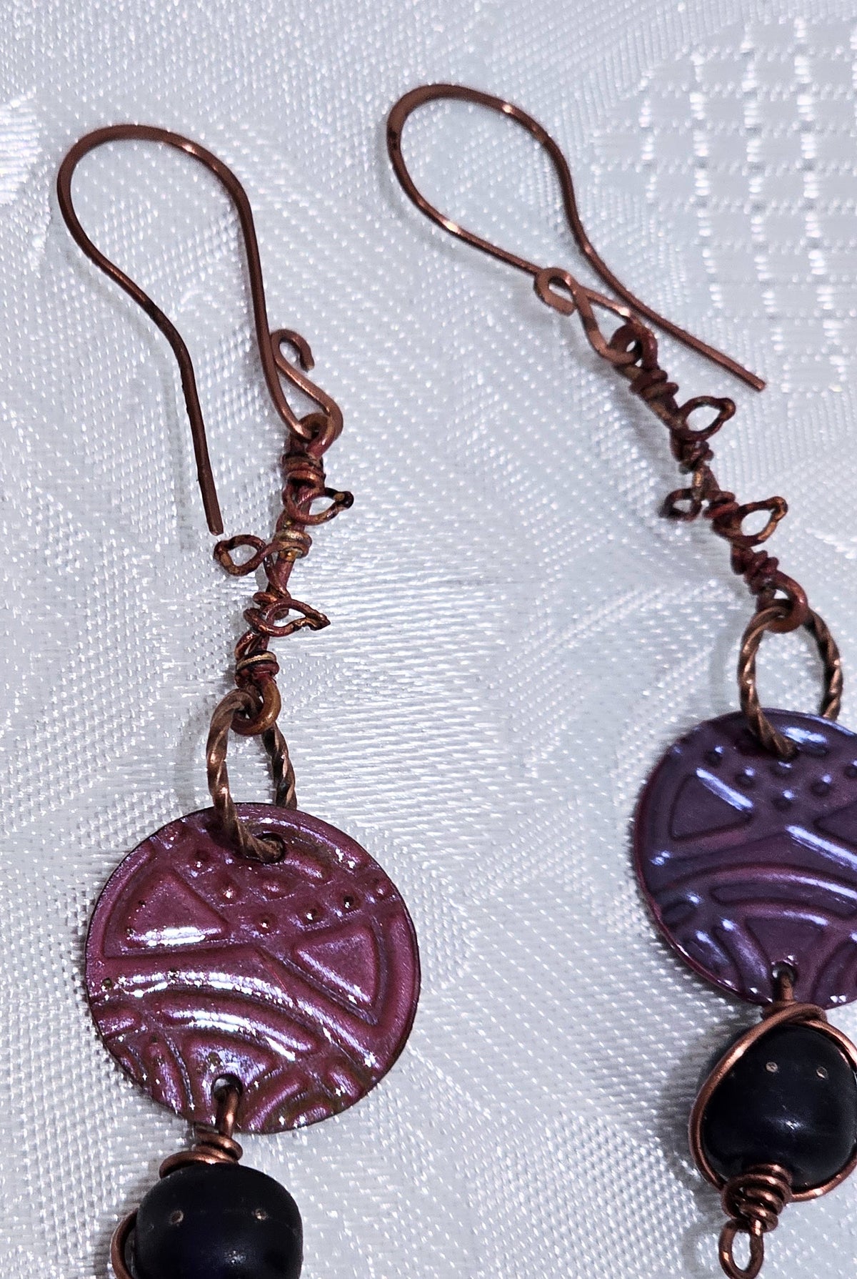 Suspended Pressed Metal Discs with Barbed Wirework Link and Black Matt Lampwork bead