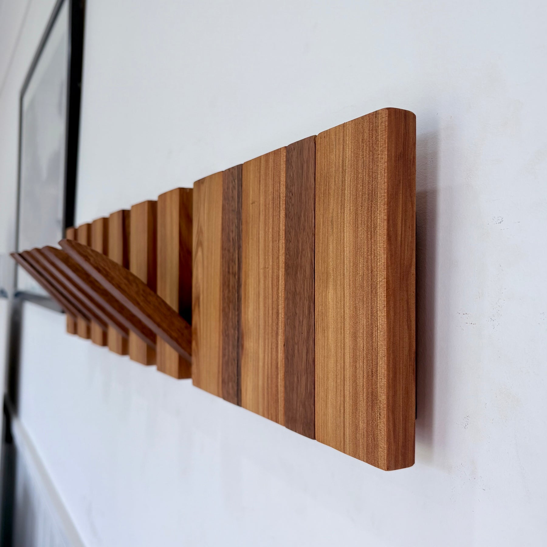 Two tone spotted gum and cypress horizon line piano style coatrack
