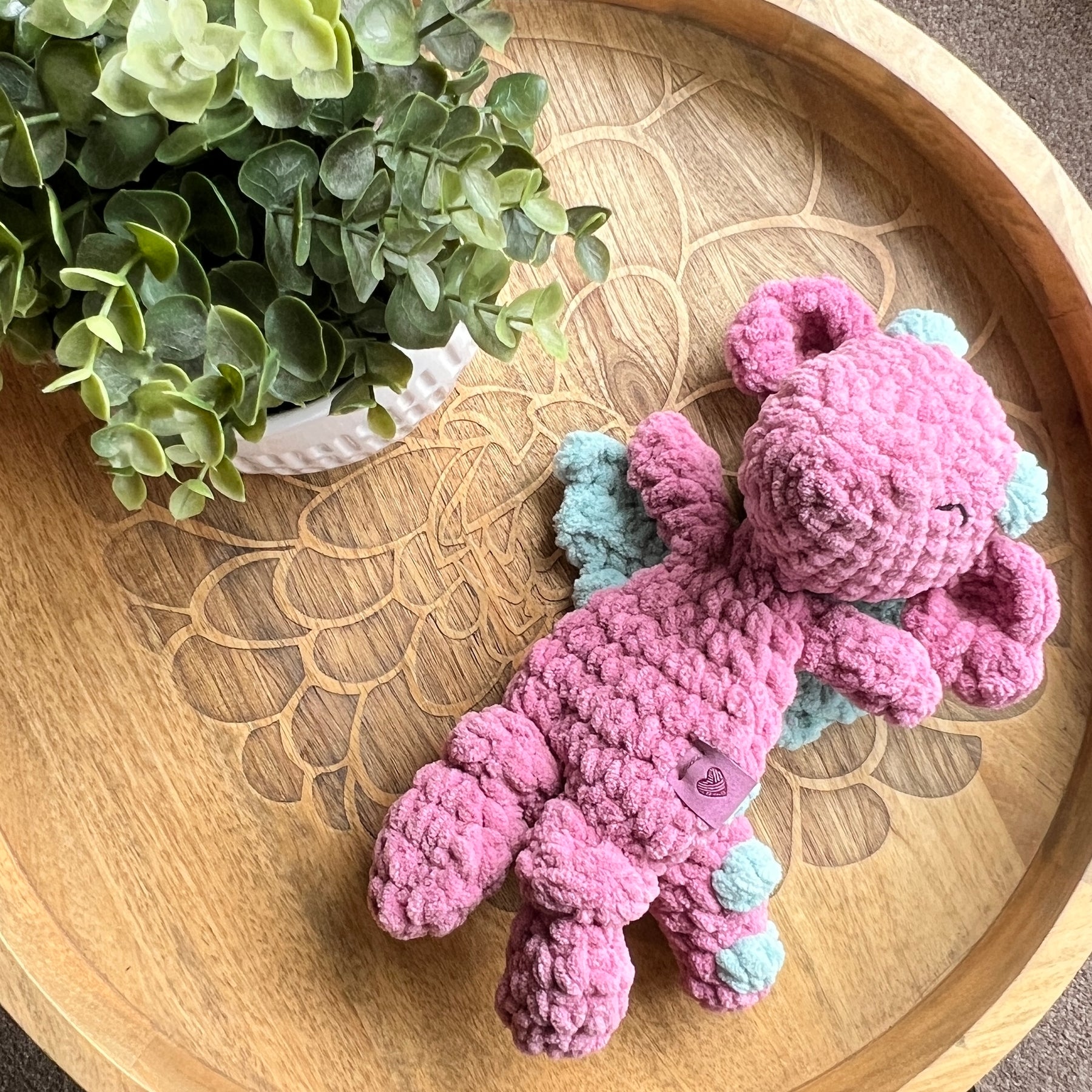 Handmade crochet Mini Dragon modern lovey with knotted legs and rainbow spikes.