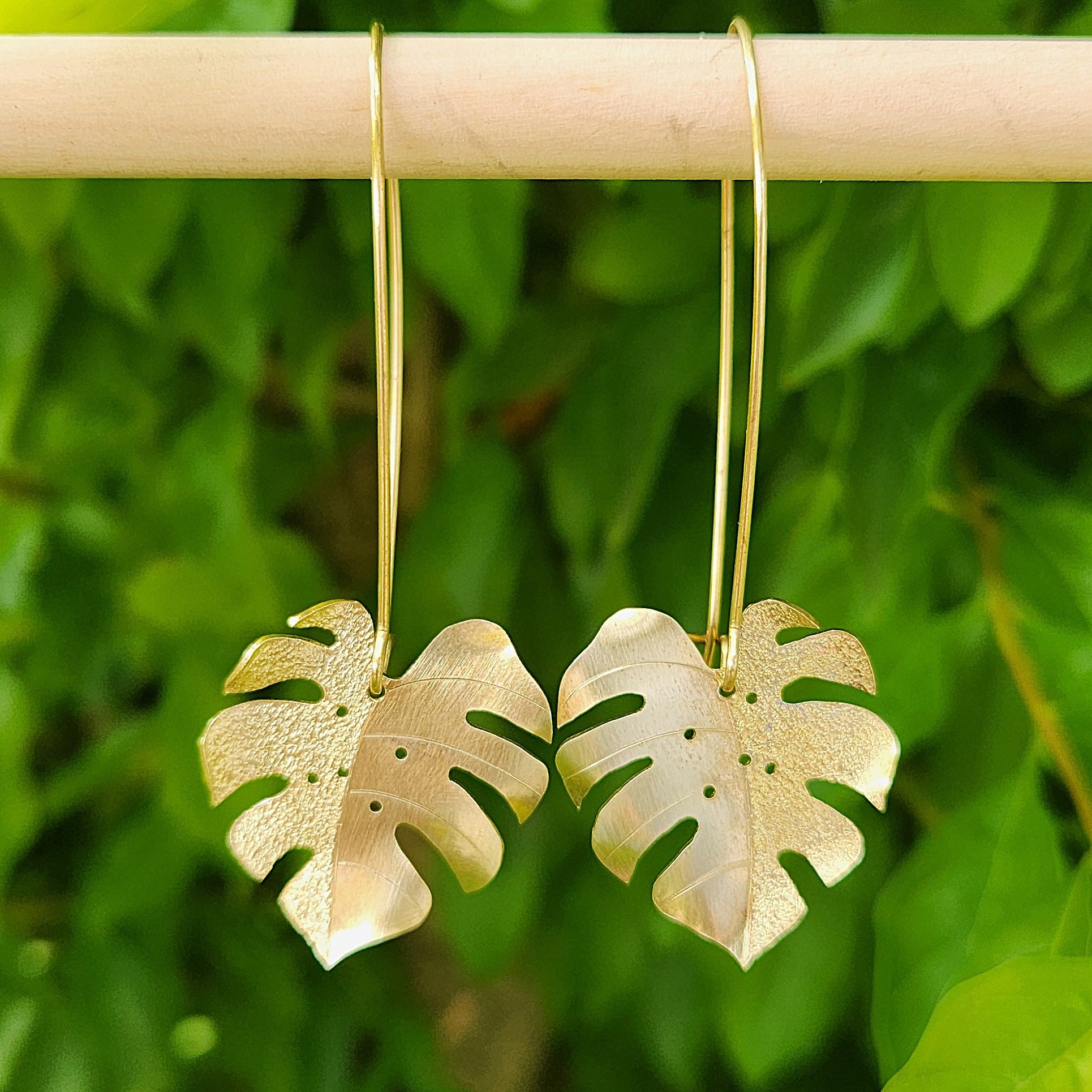 Golden tone monstera earrings