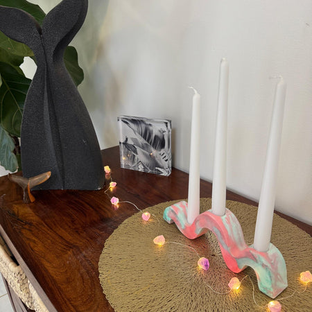 Red and green and gold wavy concrete holder for taper candles