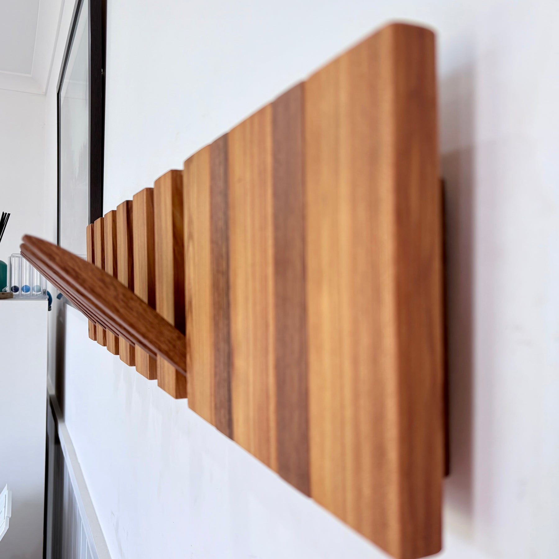 Two tone spotted gum and cypress horizon line piano style coatrack