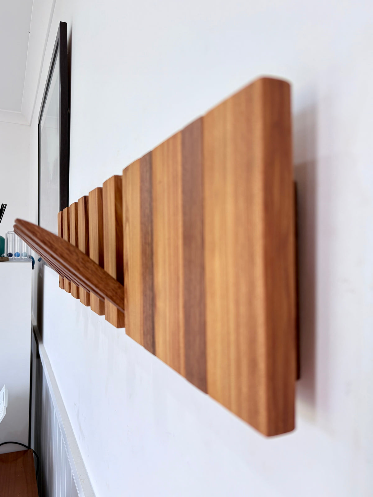 Two tone spotted gum and cypress horizon line piano style coatrack