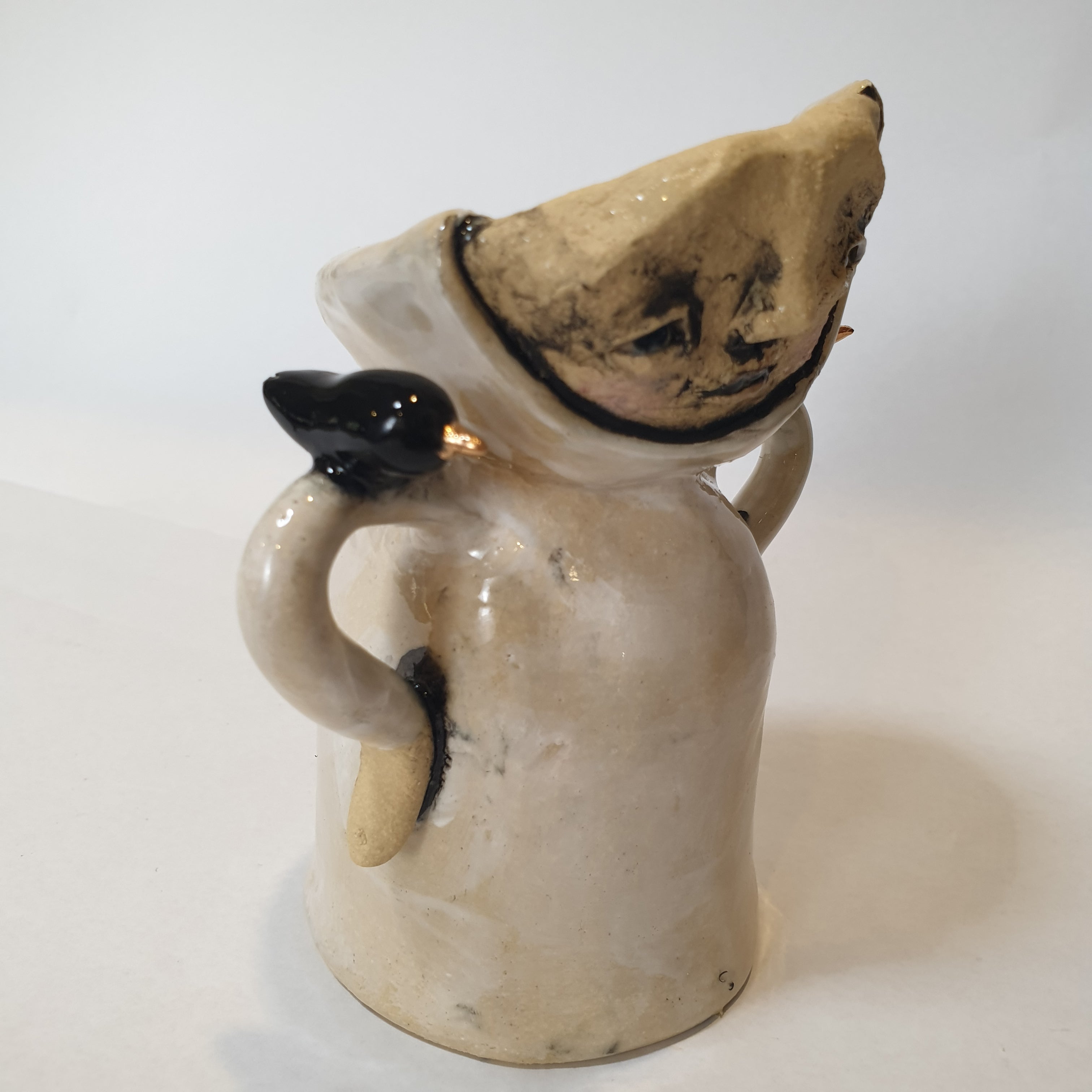 little clay person with birds