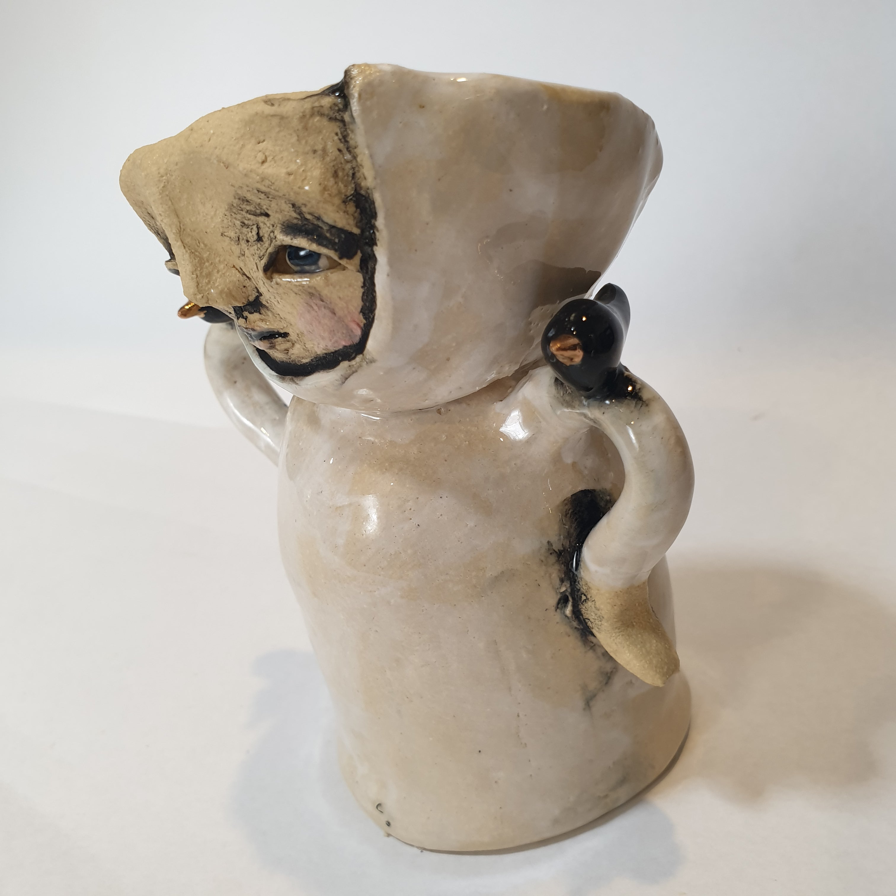 little clay person with birds