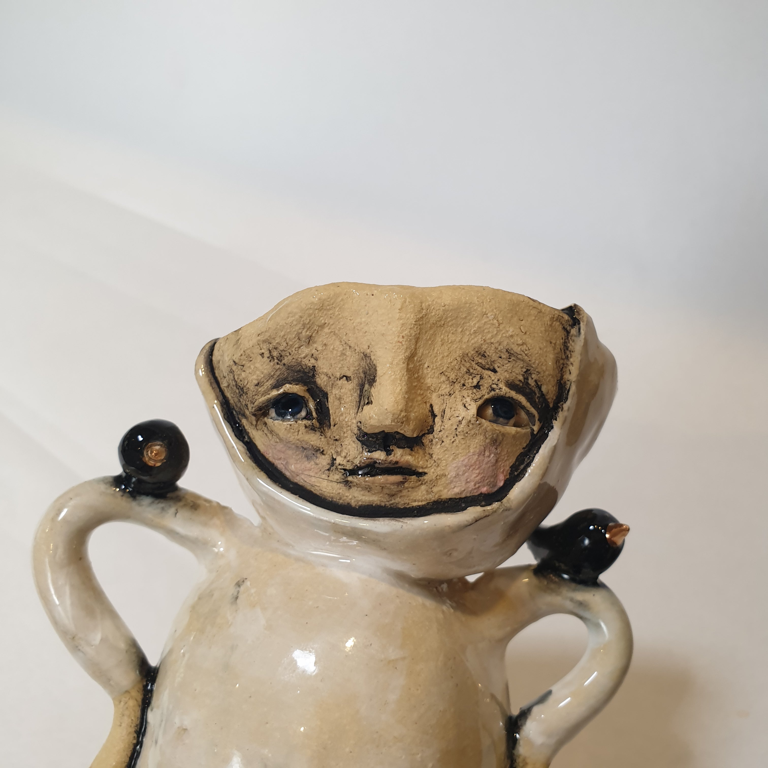 little clay person with birds