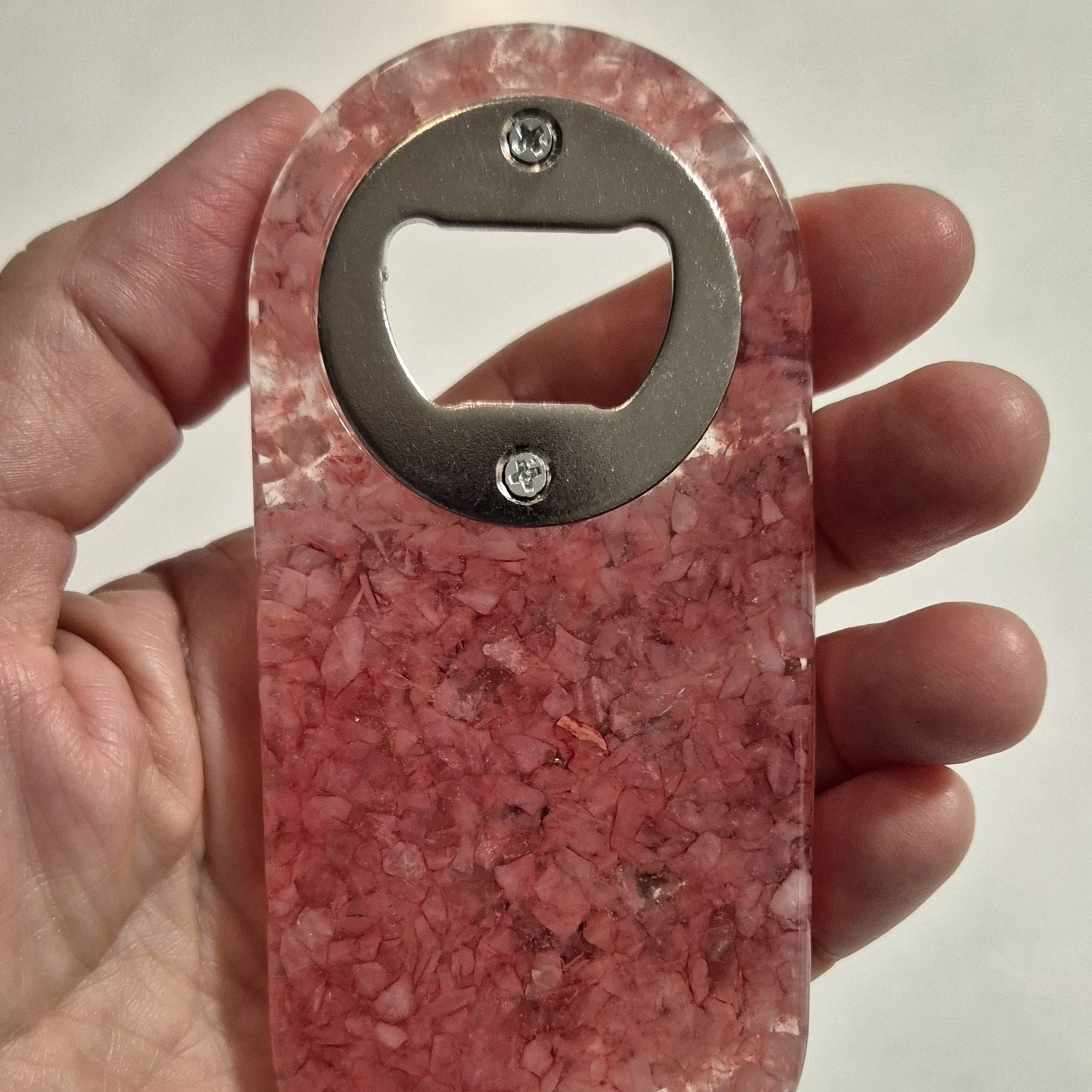 Resin bottle opener with inlaid rose quartz stones