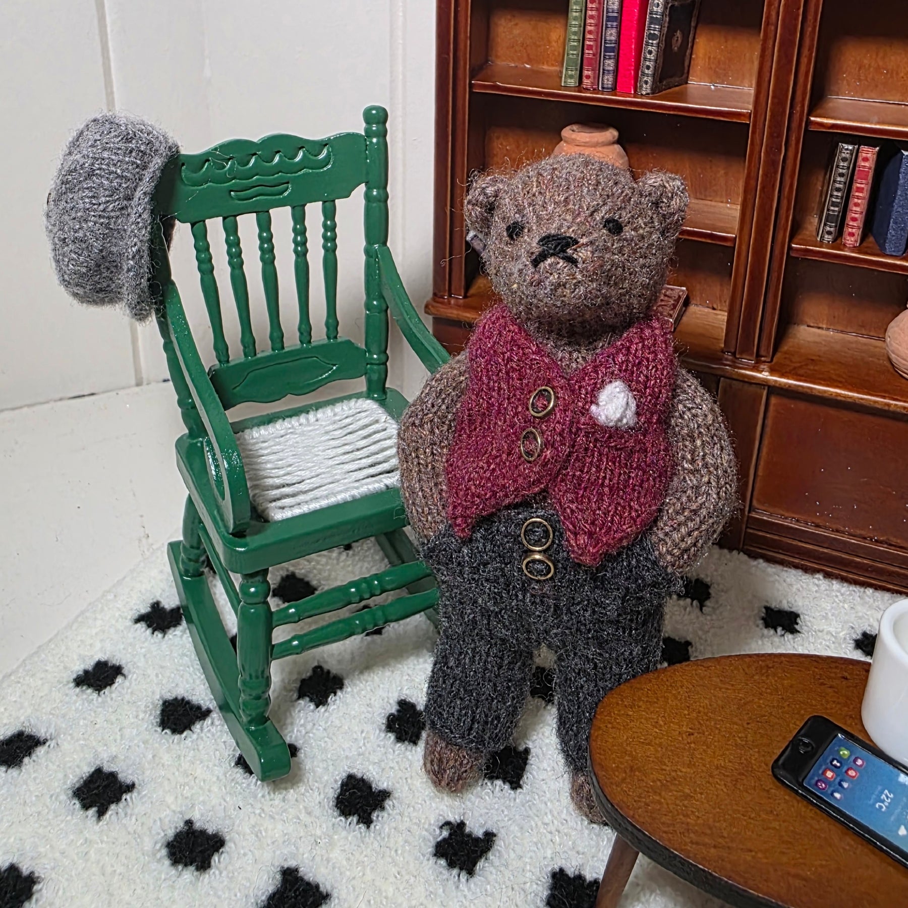 Small hand knitted bear with removeable clothes